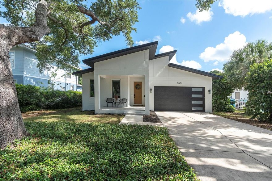 Just minutes from the historic waterfront village of Gulfport, this modern 2022-built residence perfectly merges designer luxury with elevated outdoor living. Spanning 1,680 square feet of thoughtful single-level design, this 3-bedroom, 2-bathroom home features a seamless indoor-outdoor layout tailored for the Florida lifestyle.
At the heart of the home, the open-concept living area flows into a kitchen equipped with custom cabinetry, a striking waterfall island, premium Café appliances, and a dedicated beverage fridge. Luxury is woven throughout, featuring automatic electric shades and modern lighting fixtures.
Step through to a private backyard oasis: a fully screened lanai opens to a heated and cooled saltwater pool complete with a sun shelf, all framed by mature tropical landscaping. Additional highlights include a spacious attached garage accessed via an interior laundry room. Crucially, the property is located in Flood Zone X. Positioned perfectly between pristine Gulf beaches and vibrant downtown St. Petersburg, this exceptional home provides the perfect balance of privacy, modern style, and unbeatable proximity.