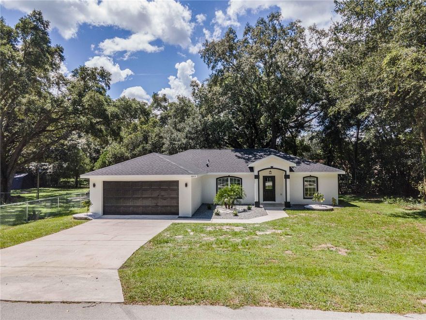 MOVE-IN READY!! Located in the family-friendly neighborhood of Orange Blossom Hills this 3BR/2BA RENOVATED home with a den/office is within arm's length of THE VILLAGES, Mulberry Grove Plaza, Ocala, shopping, dining, schools, and much more. Situated on a .22 acre lot this home offers plenty of space to stretch out arms without feeling stacked. Comprised of 1,610+/- sqft under air this home features a split floor plan with vaulted ceilings, LVP flooring, an inside laundry room, a 2-car garage, a covered patio, and a Rear screened-in porch. The kitchen features quartz countertops, stainless steel appliances, and soft-close cabinetry. The master bedroom is enhanced with his/her closets, an ensuite including his/her sinks, and a walk-in shower with a corner soaking tub. The spare bedrooms are spacious with a shared hall bath and linen closet. With plenty of space for your family, you'll love everything this home offers with a great neighborhood. Move-in Costs are First month's rent ($2,195) and Security Deposit ($2,195). Tenant application approval is required. No Smoking.