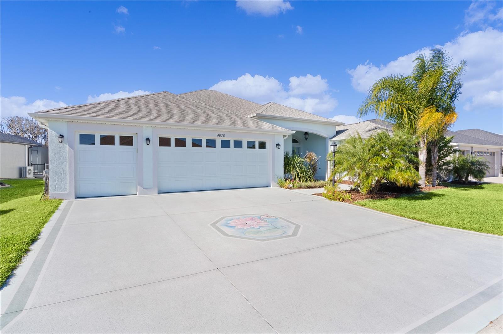 ~$30,000 PRICE REDUCTION!~ ~WATER VIEW~ ~POOL & SPA HOME~ ~2020 ROOF~ ~GC GARAGE~ ~SOLAR SAVINGS~ ~FURNITURE PACKAGE AVAILABLE SEPARATELY~ This stunning 4/3 WOODSIDE DESIGNER POOL home, nestled in the Village of CHITTY CHATTY, offers a blend of elegance, comfort, and functionality. Its inviting exterior features a PAINTED DRIVEWAY, 2-CAR GARAGE, GOLF CART GARAGE, and a charming courtyard leading to a LEADED GLASS front door with a matching sidelight. Upon entering, your eyes are drawn to the sliding doors in the living room, revealing a spectacular view of the SOLAR HEATED SALTWATER POOL, WATER VIEW and LARGE BIRDCAGE ENCLOSURE—ideal for relaxation or entertainment. The interior boasts 5-1/2” BASEBOARDS and exquisite PORCELAIN TILE FLOORING throughout, enhancing the seamless flow of space. There is also UPDATED LIGHTING and FANS in each room. The dream kitchen is paradise, featuring QUARTZ countertops, a FARMHOUSE SINK, stainless steel appliances, a TILE BACKSPLASH, under- and over-cabinet lighting, rollout shelves, wall oven, electric cooktop and stylish PENDANT LIGHTING above the spacious BREAKFAST BAR. Additional storage is provided by a central island, a hallway pantry, as well as extra cabinetry in the eat-in area - perfect for all your culinary needs. The primary suite offers a serene retreat with its tray ceiling, ceiling fan, 2 oversized closets, and a luxurious en-suite bath. The en-suite features elegant cabinetry, NEW DOUBLE GLASS SINKS, GRANITE countertops, a tiled ROMAN SHOWER, and a separate commode. Guests will feel at home in the generously sized secondary bedrooms, 2 with a MURPHY BED and the other with ample space and built-in drawers in the customized closet, both conveniently located near the stylish guest bath. A versatile 4th bedroom can serve as an office or hobby space with another full bath with WALK-IN SHOWER just across the hall. Both guest baths have GRANITE countertops. The laundry room includes upper and lower cabinets and a laundry sink for added convenience. Step outside to the expansive 38’ x 9’ lanai with a birdcage enclosure, covering the pool and HOT TUB. The serene water view enhances the outdoor experience, making it perfect for relaxing afternoons or lively gatherings. The garage also has ATTIC STAIRS for additional storage, a WATER PURIFIER and WATER SOFTENER plus EPOXY floors. The ROOF, HVAC & Hot Water Heater are all 2020. Solar panels also provide monthly savings on your electric bills! The Chitty Chatty Pool is just down the street, and you are conveniently located near Route 44, shopping, dining, and via the CHITTY CHATTY BRIDGE, minutes from LAKE DEATON PLAZA and BROWNWOOD TOWN SQUARE! This home truly embodies luxury living in a prime location.
