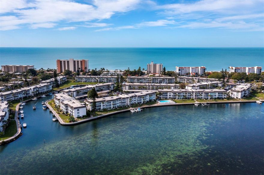 Set in the sought-after Longboat Harbour community on Longboat Key, this beautifully updated 2BR/2BA walkout residence offers 1,152+/- sq. ft. of inviting waterfront living. Your breath will be taken away by the peaceful mangrove-lined views that shape a relaxed, effortless way of life. The moment you step inside, the level of care and style is unmistakable, as crown molding, maintenance free tile and laminate floors create a warm, welcoming ambiance that draws you toward the picturesque backdrop beyond the living space. The kitchen has been thoughtfully updated with stone countertops, all-white cabinetry, stainless-steel appliances, a tile backsplash (with under cabinet lighting), recessed lighting and a tray ceiling with fan. A large breakfast bar connects the kitchen to the dining area and living room, giving the entire layout an open, seamless flow. The former terrace has been enclosed to create an extended Florida room wrapped in sliders with privacy shades, offering a stunning vantage point over the water and direct walkout access to the outdoors. It’s a rare feature that brings the waterfront right to your door and is only steps away from one of the bayside pools. The primary bedroom enjoys soothing water views along with a graciously redesigned bath featuring rich wood cabinetry and refined finishes. The guest bedroom is equally comfortable for family or visitors, and the updated guest bath continues the home’s cohesive style. Residents of Longboat Harbour enjoy an exceptional list of amenities across both bay and beach, including berths for more than 50 boats on the Sarasota Bay side and exclusive Gulf access through a private beach house with restrooms, showers and dedicated parking. Additional amenities include 4 swimming pools, a tennis court, fitness center, wood shop, art studio, banquet hall and an active schedule of social events.