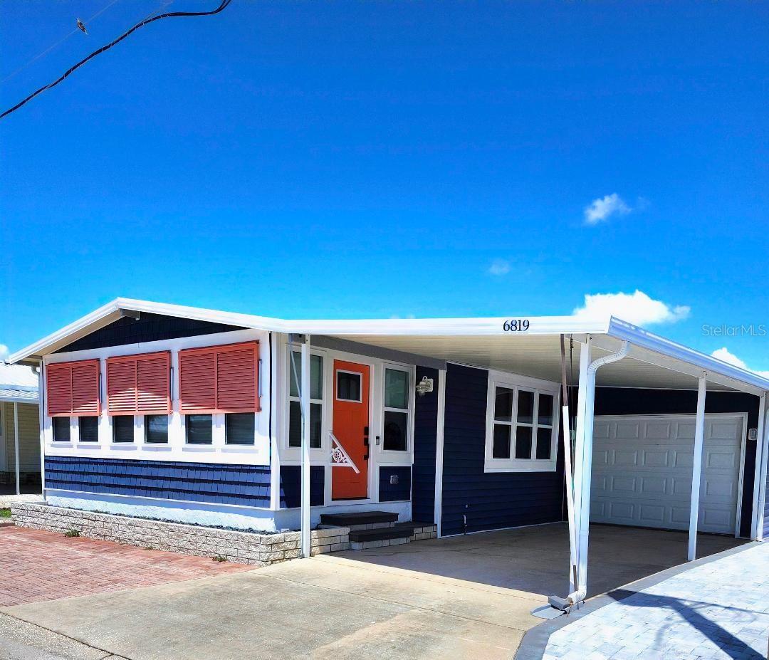 BOLD AND STRIKING RENOVATION! This low maintenance, 2 Bedroom, 2 Bath COASTAL COTTAGE with attached Garage is situated on an oversized lot in the top-tier, active 55+ Trailer Estates community. The Open Concept and expansive living spaces are wonderful for entertaining, with high vaulted ceilings and tons of natural light! Luxury vinyl plank floors throughout. Kitchen boasts a center island with breakfast bar, plenty of Shaker style cabinets, modern stainless steel appliances and quartz countertops. Generous Primary Bedroom with built-in desk. Ensuite Primary Bath has dual sinks and roomy walk-in shower. Large separate Laundry Room right off the Kitchen. Impact windows / doors and Bahama shutters. Every square inch of the home has been thoughtfully designed to maximize a relaxed, laid back lifestyle. Attached Garage is 11.5'x27'. An extra 12x10 shed for workshop or storage. You own the land. Boaters have direct access to Sarasota Bay from the Marina. Enjoy the large, heated community pool, hot tub, gym and wood shop. The community buzzes with pickleball, shuffleboard, kayaking, horseshoes, bocce, dancing and more. A US Post Office on site. 10 minutes to Sarasota-Bradenton Int'l Airport. Convenient to shopping, restaurants, the Arts and everything in Bradenton/Sarasota.
