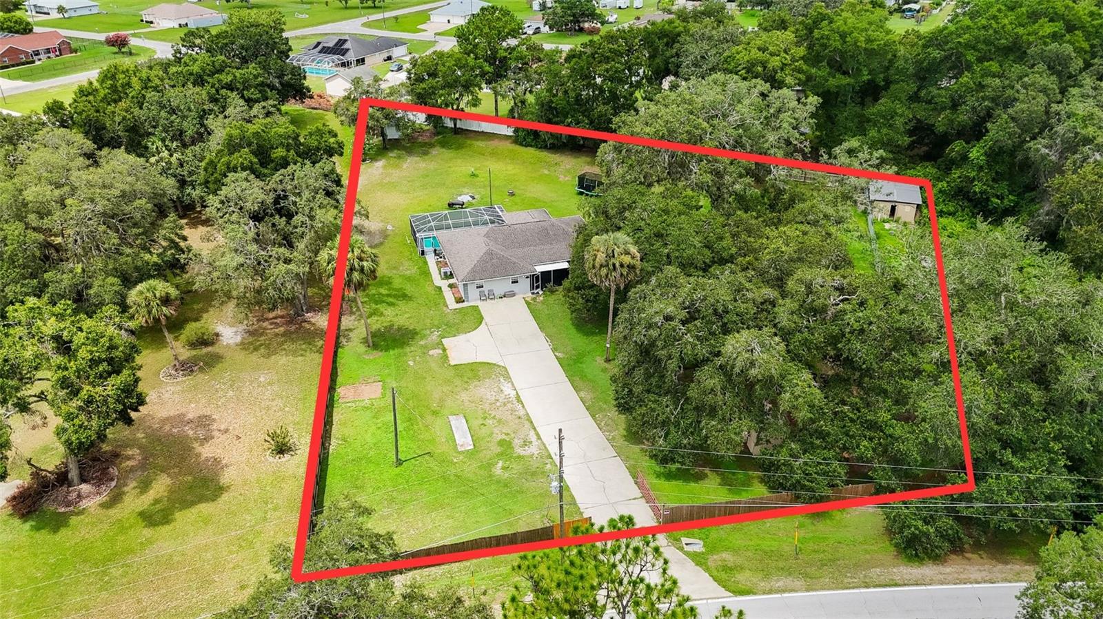 Set on a picturesque 1.46-acre lot surrounded by majestic oak trees, this 4-bedroom, 2-bathroom pool home in the desirable Edgewater Estates of Summerfield offers the perfect combination of privacy, space, and location—just minutes from The Villages. Inside, enjoy a cozy living room, a functional kitchen with breakfast bar, and a dining area with French doors that lead to a screened lanai and sparkling in-ground pool with birdcage enclosure—ideal for relaxing or entertaining. The owner’s suite features a walk-in closet, en suite bath, and direct pool access. Three additional bedrooms provide flexibility, including one with a queen-size Murphy bed. Additional highlights include a whole-home intercom system, a detached 1-car garage with electric, privacy fencing, and an electric/solar-powered gated entrance. Residents enjoy private lake access to Little Lake Weir with a key-only boat ramp located just across the street, and Carney Island Nature Preserve is just 4 miles away. Convenient to shopping, restaurants, and medical facilities. Roof replaced in 2018. Refrigerator, range, washer, and dryer do not convey.