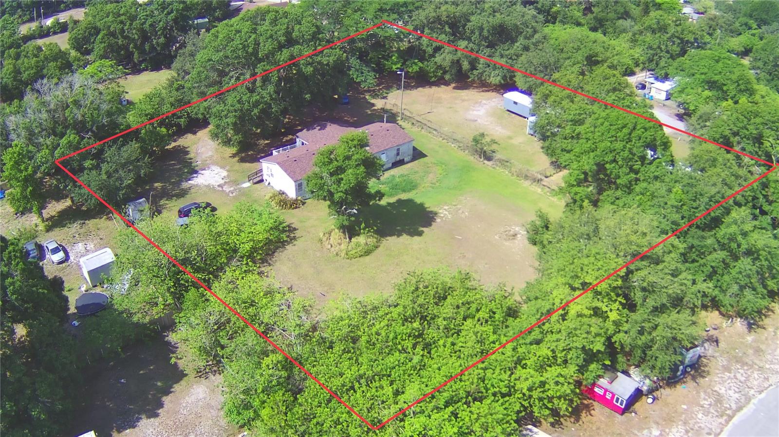 PRICE IMPROVEMENT...RARE INVESTMENT OPPORTUNITY!! This gems offers 3 Houses for the price of 1 on 1.87+/- acres. This property features 3 manufactured homes with huge upside potential. Great opportunity to live in the main house and rent the other 2 or have your own mobile home park. The Main House (Triple wide) offers 5 bedrooms and 3 full bathrooms. It also has a spacious open floorplan and oversized kitchen. The second home (singlewide) is located in front the main house and offers 3 bedrooms and 2 bathrooms. The third house (singlewide)is located in front of the main house to the far left and features 2 bedrooms and 2 bathrooms. This property is equipped with 3 septic tanks and individually metered electric and water service, ensuring convenience and efficiency. All 3 of the homes needs some TLC but offer lots of potential for future value. This property is located close to, schools, shopping, medical facilities, and makes for an easy commute. Don’t miss out on this amazing investment.