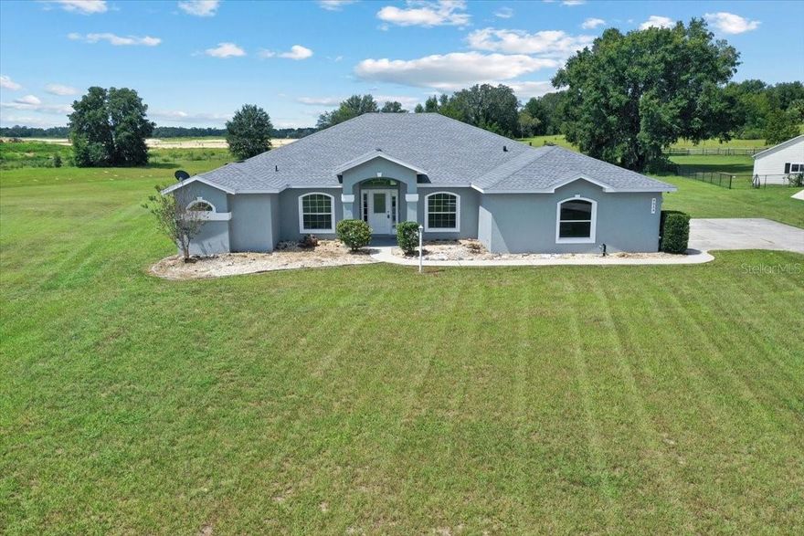 Spacious and beautifully updated, this 4-bedroom, 2-bath home in Belleview’s desirable Golf Park neighborhood offers the perfect blend of comfort, style, and outdoor living. Nestled on a generous 1.93-acre lot, this 2,754 sq ft residence features soaring high ceilings, fresh interior paint, and brand new luxury vinyl flooring throughout the main living areas. The heart of the home is a large living room anchored by a cozy fireplace—ideal for relaxing evenings. The split-bedroom layout ensures privacy, while the open kitchen flows seamlessly into the Florida Room, where you'll find a brand new summer kitchen—perfect for entertaining year-round. Step outside to enjoy the peaceful, park-like setting with plenty of space for outdoor activities, gardening, or future enhancements. Whether you're hosting gatherings or seeking quiet retreat, this home offers the flexibility to fit your lifestyle. Don't miss your opportunity to own this move-in-ready gem in a quiet, established community. Schedule your private showing today!