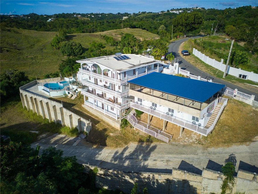 Panoramic Ocean-View Inn & Private Residence in Rincón Presenting an exceptional investment opportunity in one of Rincón’s most coveted enclaves. This four-story estate showcases remarkable versatility for private living or operating a boutique hospitality experience, all framed by mesmerizing, endless ocean views. Main Level: A primary residence featuring 3 bedrooms and 2 full bathrooms. Lower Levels: Hotel–style accommodations featuring 9 private suites, each with its own bathroom. 2 suites include a separate living area and full kitchen. Most suites come furnished with a bed, mini-fridge, air conditioning, and independent entry—ideal for short-term rentals. Expansive shared balconies capturing sweeping, cinematic ocean vistas. Stunning infinity-edge pool, perfectly positioned to savor Rincón’s iconic, golden sunsets. Newly renovated covered terrace, thoughtfully designed for entertaining, intimate events, or serene relaxation—always with the ocean as your backdrop. Commercial-ready bar area, offering an exceptional setting for hosting, mixology experiences, or additional revenue opportunities. This property brings together generous space, great comfort, and serious income potential. A standout opportunity for investors looking for a turn-key short-term rental setup or a unique coastal home with unforgettable views
