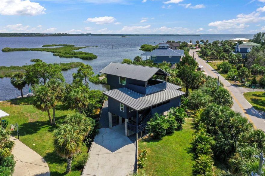 One or more photo(s) has been virtually staged. Welcome to your dream coastal retreat on Pine Island in Weeki Wachee, where every sunrise and sunset paints the sky in vibrant hues and you have water views from every room! This stunning 3-bedroom, 2-bath home has been transformed into a luxurious haven with top-notch coastal modern finishes that blend elegance and comfort. Imagine driving up to your oasis, parking under your elevated home, and relaxing in a charming seating area with serene water views. Your private paradise features a brand-new sea wall with steps leading to your secluded beach and direct gulf access—perfect for your boat or launching a kayak. The home itself is a masterpiece, with new hardie siding painted in deep blue that complements the shimmering waters. Expansive balconies with new composite decking and sleek cable railings offer perfect vantage points for savoring the breathtaking surroundings. Inside, the open-concept design showcases picture windows and wall-to-wall sliders framing spectacular water views. The kitchen is a chef's delight, with custom cabinetry, exotic level 5 natural stone countertops, a custom designer backsplash, and state-of-the-art GE café series appliances. Every detail, from custom light fixtures to the chic bar area, has been thoughtfully crafted to create a functional and beautiful space. Luxurious LVP flooring flows throughout, while smooth level 5 walls enhance the coastal vibe. The guest bathroom, with custom tilework and designer fixtures, exudes sophistication. Each of the two main-floor bedrooms opens onto private balconies overlooking the water. Ascend to the top floor, where the primary suite awaits—an expansive sanctuary with vaulted ceilings and eastern and western views over the Gulf. New hurricane-impact windows and sliders flood the space with natural light. The master bath is a spa-like retreat with a spacious closet, separate tub and shower, and a private balcony overlooking the water, where you can enjoy your morning coffee or soak in the oversized tub with views of the moonlit sky. This one-of-a-kind property offers more than just a home; it’s a lifestyle. Nestled on Pine Island, you'll be surrounded by nature, with dolphins, manatees, and otters as your neighbors. A boat launch for small to mid-size boats is just steps from your door, and Weeki Wachee River State Park is only 5-10 minutes away. With no rental restrictions, this home also offers incredible potential as a luxury vacation rental. Make it your private getaway or an income-generating paradise. Take a leisurely walk or hop on your golf cart to Alfred McKethan Pine Island Park, a 3-acre Gulf-front oasis with a beach, playground, volleyball courts, and a concession stand. Pine Island is a charming community, 6 blocks long and 2 blocks wide, with only about 40 homes. The optional HOA ($40/year) grants access to a private community dock, boat ramp, and beach. Experience the magic of island living—your ultimate Florida escape awaits. Schedule your showing today and make your island dreams come to life!