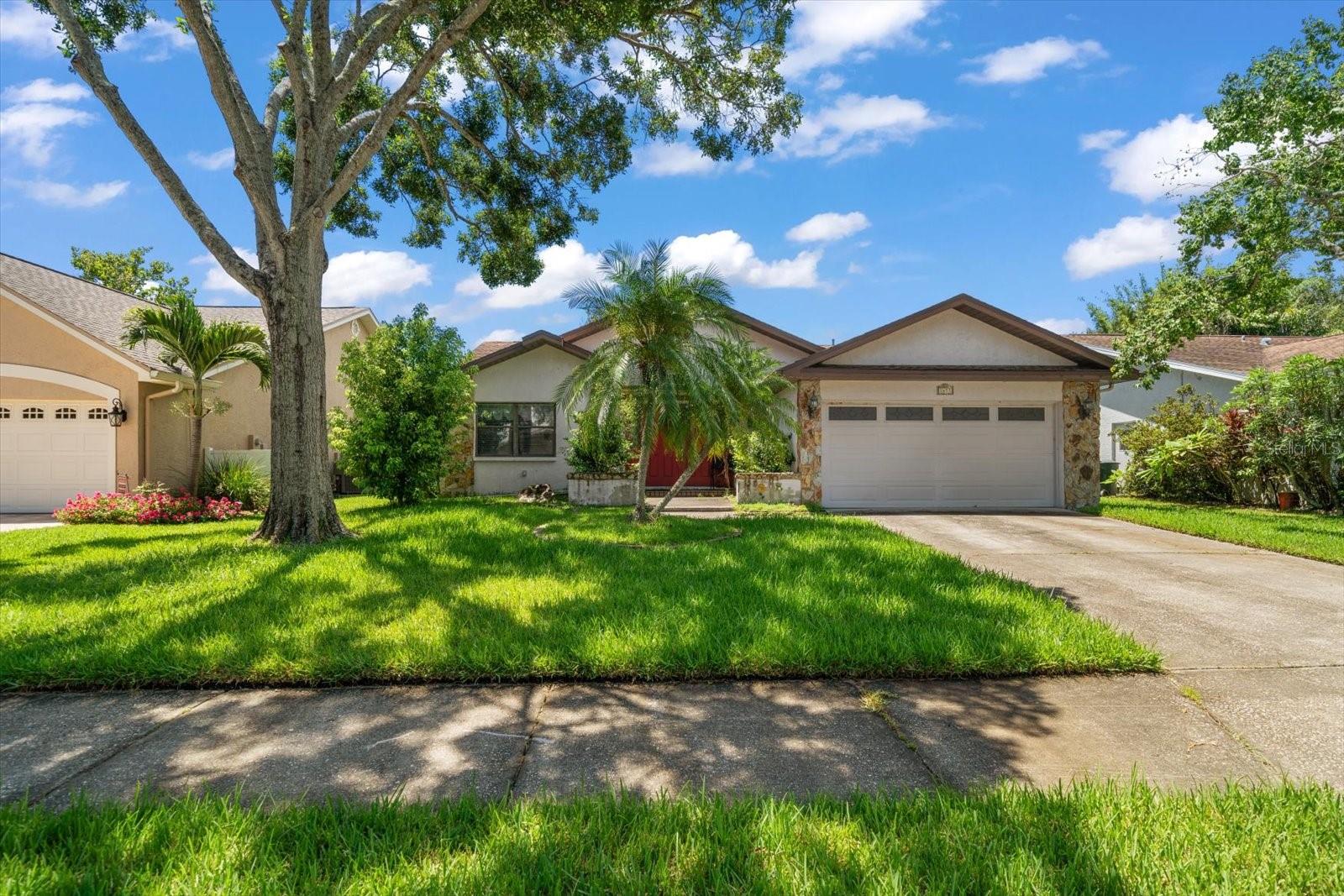 Welcome to this Dunedin charmer, an investor’s dream or ideal Florida retreat, perfectly located just a short golf cart ride to vibrant Downtown Dunedin through the peaceful and picturesque Scottsdale Bluffs neighborhood. Enjoy leisurely strolls along quiet, tree-lined streets, discover boutique shops, dine by the waterfront, or take part in the many year-round outdoor events and activities that make this community so special. Step through the double entry doors into a spacious living and dining room combo with vaulted ceilings, creating an airy and inviting space perfect for entertaining. The adjacent kitchen offers ample counter space and easy flow for gatherings. A light-filled Florida room with walls of windows overlooks the private, fenced backyard, offering additional living space or the perfect spot to unwind. The split-bedroom floor plan includes a generous primary suite with a custom walk-in closet and ensuite bath featuring a walk-in shower and large vanity. Additional bedrooms provide privacy and comfort for guests or family and share a full hall bath with a tub/shower combo. With its prime location close to Honeymoon Island State Park, world-famous beaches, and the charm of downtown Dunedin, this is an exceptional opportunity in a truly unbeatable location. Don’t wait—this one won’t last!