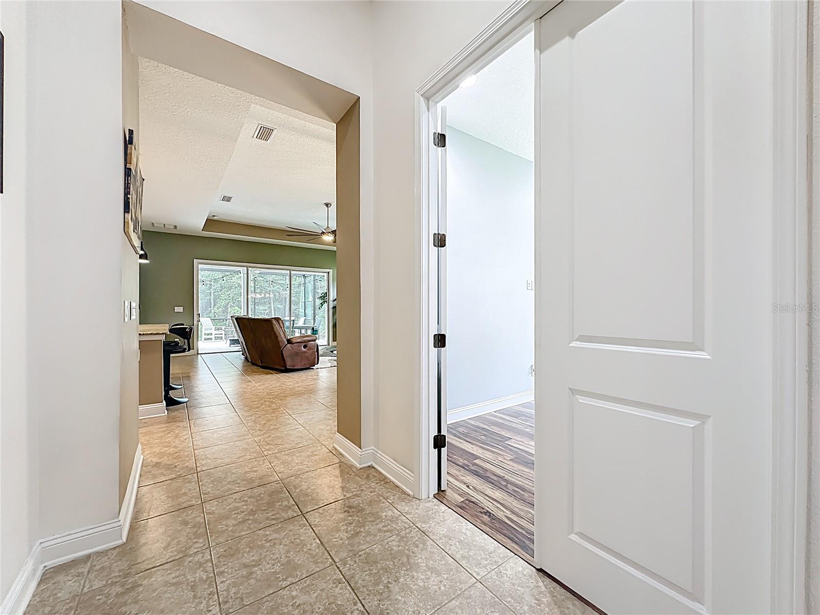 Welcome to 297 Shadow Ridge Trail, an upgraded ICI-built Sienna model located on a cul-de-sac and nearly surrounded by preserve. This 3-bedroom, 2.5-bath home with a dedicated office offers 2,069 sq ft of open living space. Features include a spacious living area with a custom shiplap wall and fireplace, a kitchen with granite countertops, stainless appliances, a walk-in pantry, and a large island. The primary suite offers one walk-in closet and a spa-like bath with dual vanities and a walk-in shower. The laundry room includes cabinetry and is plumbed for a utility sink. A 3-car tandem garage provides ample storage. The highlight is a 38’ x 21’ screened lanai with a full outdoor kitchen, covered dining, and hot tub zone. Located near Pine Island Academy, Crosswater Park, and Nocatee amenities, including water parks, trails, and kayak launches.