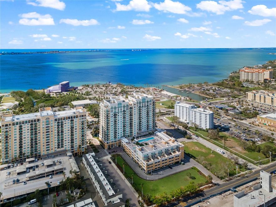 Welcome to an exciting blend of privacy, space and style in this unique multilevel end-unit townhome with your own private entrance, set within the coveted Alinari at Rosemary Place in downtown Sarasota. Enjoy 1,734 sq. ft. of remodeled interior living space & your very own private 942 sq. ft. Rooftop Deck with sweeping views of Sarasota Bay, Sarasota city skyline, resort-style pool & spa deck, & unforgettable sunsets. 1 of only 6, private townhomes located just off the pool—& the only one currently available—this residence is truly a rare offering. Upon entering at your very own private entrance, cross the threshold & enjoy soaring 18-foot ceilings showcasing ample windows that create an expansive, light-filled interior that seamlessly blends w/the outdoor scenery with high-end finishes, including custom Venetian plaster walls, designer lighting, custom plantation shutters and freshly painted interior. The kitchen is well-appointed with quartz countertops, large bar counter, stainless steel appliances, custom designer soft close cabinetry with ample storage space and an oversized pantry. The adjacent spacious dining area has ample room for 6-8 and flows seamlessly into the living room creating the perfect open-concept floor plan for relaxing and entertaining with friends. The versatile 2nd bedroom/den with an adjacent full bath was previously used as both by the current owner. See images of the custom Murphy Bed with storage. Town records classify unit as a 1BR, but it lives comfortably as a 2BR thanks to the sleek sliding partition door. Open the French doors to a spacious oversized terrace (approx. 642 sq. ft.) which is one of 3 private outdoor spaces. Upstairs, the expansive Primary Suite features its own private balcony, walk-in closet and large en-suite bath with dual sinks, soaking tub, large separate walk-in shower and linen closet. Continue to your very own Private Rooftop Terrace Retreat, which spans the full length of the residence and sets the stage for true luxury overlooking the city skyline and Sarasota Bay making it an inviting space for relaxation, al fresco dining or entertaining. Additional highlights include an oversized laundry room w/built-in cabinetry, retractable screens for airflow throughout, generous storage, two AC units, custom window treatments, upgraded ceiling fans, custom stainless stair railing, beautiful tile floors and two elevators adjacent to the unit.  Alinari residents enjoy 24-hour concierge and security with onsite management staff, an 80’ heated lap pool & spa, fitness center, private cinema, outdoor grilling, business center, club room with bar and entertaining kitchen, social and tea rooms, wine cellar with personal locker (a favorite spot for casual wine gatherings), billiards, three guest suites to accommodate additional overnight guests, a large dog park, designated garage parking, a climate controlled storage unit, indoor bicycle storage and an active social committee that plans engaging events throughout the year Alinari residents can rest assured as the building was built at 16’ feet above sea level and is located in an X flood zone and has passed its structural survey with no assessments coming up. Total indoor and outdoor living space: 3,389 sq. ft. all just minutes from Sarasota Bay, Van Wezel, St. Armands Circle, Lido Beach, Sarasota’s vibrant downtown shopping, fine dining, marinas, and expansive arts and cultural offerings.