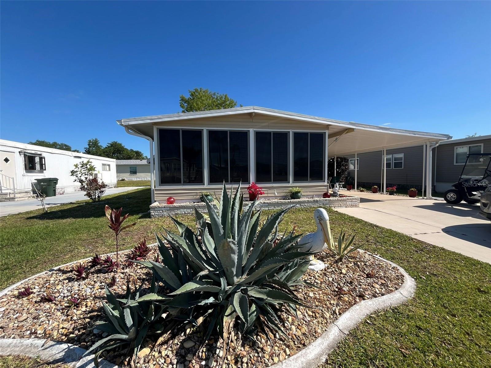 Welcome to your new home! This spacious and fully furnished 2-bedroom, 2-bath manufactured home offers comfort, convenience, and style. With a thoughtfully designed home, each bedroom has easy access to its own full bathroom. The home comes move-in ready with tasteful furnishings, a fully equipped kitchen, cozy living space, and laundry room in the carport. This home has everything you need. The community features all kinds of activities for the active resident, including a fitness center, 2 pools, spa, tennis, pickleball, shuffleboard, bocce courts, rentable boat slips, billiards, crafting, card games, water aerobics, art classes, woodworking shop, etc. Too much to list! Be sure to call us right away before this one gets away!