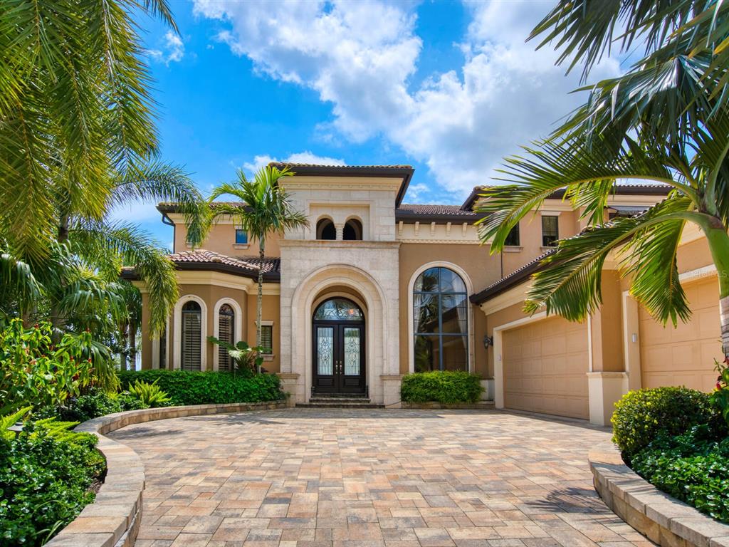 Exceptional waterfront living with full river views from this amazing John Cannon model home located in the gated community of Riviera Dunes. Enjoy sitting riverside watching amazing sunsets, dolphins cruising by and city night lights of downtown Bradenton. Boat slip will accommodate up to a 45-by-18.5-foot vessel and is steps across the street in a highly protected marina. With several screened lanais, open space around the infinity pool and spa, outdoor grilling area and luscious landscaping for total privacy, this home is truly designed for entertaining with family and friends. First level offers master suite with sitting area, dining and living room with two-story coffered ceiling, wet bar and double-sided fireplace to the family room, chef kitchen with gas cooktop, center island, walk-in pantry and an en-suite guest bedroom. Second level has second master/guest suite with a sitting area, wet bar, loft area, game/bonus room with kitchenette, large screened lanai and bedrooms four and five. Plenty of walk-in closets and storage, water heater and three ACs replaced two years ago, three-car garage and generator are a few extras. Amenity center includes gym, tennis and heated pool. This popular waterfront community allows boat access to Tampa Bay, Intracoastal Waterway and the Gulf of Mexico. Located minutes to world-renowned beaches, dining, shopping, hospital, Emerson Point Preserve, Bradenton Riverwalk and the Riviera Dunes Dockside restaurant at the marina. Easy access to I-75 and I-275 with three major airports less than an hour away.
