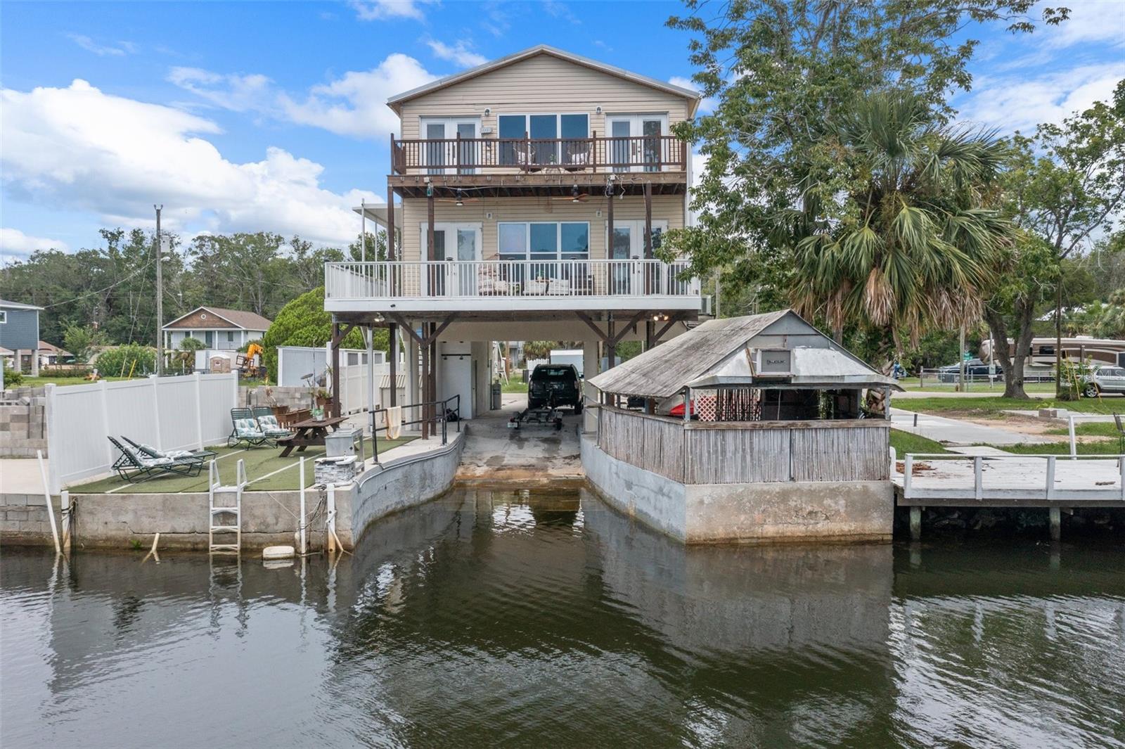 NEW ROOF TO BE INSTALLED BEFORE CLOSING!
Welcome to 6245 Island Drive, a beautifully remodeled 3-bedroom, 2.5-bath stilt home nestled on a peaceful canal just off the Mud River. Perfect for weekend getaways or full-time living, this home combines laid-back Florida charm with modern upgrades.
Inside, you’ll love the open-concept living space and brand-new stainless steel appliances in the updated kitchen—ideal for entertaining or relaxing after a day on the water. Step outside to your own tropical retreat featuring a tiki bar, shaded entertainment area, and extra storage in the shed.
With private boat ramp access right on the property, you can launch your kayak or small boat and explore the scenic Mud River and beyond. The covered carport offers space for two vehicles, plus there's additional parking for guests or watercraft.
No HOA, no fuss—just the lifestyle you’ve been searching for in the heart of Weeki Wachee.