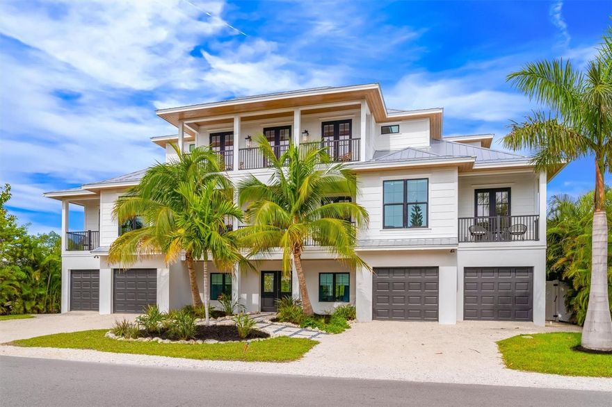 Ultimate luxury home!!  Newly built home located in the heart of Anna Maria Island yet still completely secluded backyard and VERY private- it's the best of both worlds!  One minute walk to the gorgeous white sandy beaches of Gulf of Mexico and 6 houses from Pine Avenue with many boutiques and restaurants. High end, successful rental, clean and very well maintained, perfect investment property and future bookings.  This luxury four bedroom, four in a half bathroom home has a large open concept living area with a gourmet kitchen featuring Wolf, SubZero and Bosch appliances, quartz countertops, gas stove, custom cabinetry and a 14 ft waterfall island. Step onto your huge balcony overlooking the lagoon filled with nature, ideal for dining and relaxing. Water views from almost every window. The master bedroom has a balcony, spacious walk-in closet, walk-in shower and stand-alone soaking tub. Another guest suite with its own bathroom, perfect for guests. The top floor consists of two large guest suites and a den/living room. The backyard is like your own private retreat, featuring an outdoor kitchen, large covered patio, oversized heated pool and spa, and a calm lagoon.  Hop right on your kayak or paddle boards into the lagoon to take a nature stroll and ease your mind.  Absorb the pristine surroundings and lush landscaping boosts the ultimate exclusive privacy in the backyard for your comfort. Home’s smart technology allows the thermostats, security cameras, front door bell, main lights, garage doors and sound system to be controlled from a smart phone or the built-in tablet. Other luxuries include three car (plus golf cart) garage, elevator to all floors, outdoor shower, and a tankless water heater. This is the perfect home for family gatherings and making memories - come see this ideal beach getaway to relax and be pampered with family and friends.