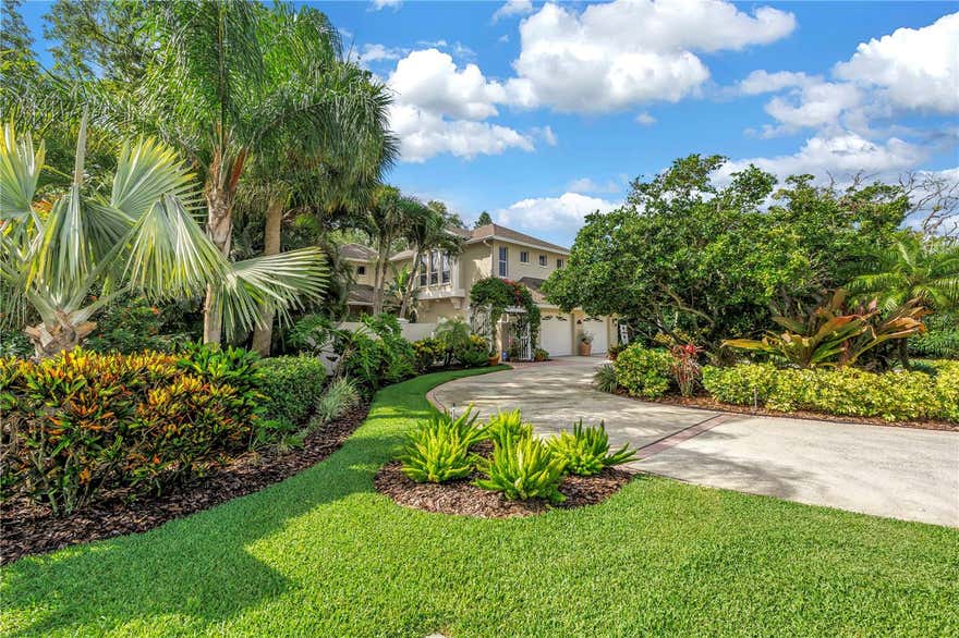 A rare offering in the coveted Carlton Estates, this extraordinary Mediterranean-inspired estate redefines luxury Florida living. Perfectly positioned on a sprawling private homesite outside the flood zone, this remarkable residence combines timeless architecture, exceptional craftsmanship, and resort-style amenities in a setting that feels worlds away, yet remains moments from the area's finest coastal attractions.
From the moment you arrive, the home's presence is undeniable. A circular drive, lush tropical landscaping, and a picturesque paved courtyard entrance create a grand welcome worthy of a luxury retreat. Inside, soaring 18-foot ceilings and sun-drenched living spaces showcase a seamless blend of sophistication and comfort, with every detail thoughtfully curated to elevate daily living.
Offering 3,462 heated square feet, four spacious bedrooms, two-and-a-half baths, and a generous two-car garage, the home has been extensively updated throughout. Rich hardwood flooring graces the upper level, while elegant plank tile flooring, crown molding, and professionally refreshed interiors and exteriors provide a refined, move-in-ready experience.
At the heart of the home, the stunning chef's kitchen was designed to gather family and friends. Solid wood cabinetry, granite countertops, premium appliances, and a custom built-in breakfast booth create a space as beautiful as it is functional. The expansive great room flows effortlessly to the outdoor living areas, blurring the line between indoor elegance and outdoor paradise.
The primary suite is a private sanctuary unlike any other, offering dual walk-in closets and a spa-inspired bath overlooking a serene waterfall courtyard, creating a daily escape that rivals a luxury resort. Upstairs, three additional bedrooms feature distinctive architectural details, including charming eyebrow windows that bathe the spaces in natural light.
Beyond the walls of the home lies a backyard retreat rarely found in Pinellas County. Set on an impressive 230-foot-deep lot, the property is enveloped by mature tropical canopy landscaping that creates a level of privacy few homes can match. The resort-style PebbleTec pool has been beautifully updated with new tile and is complemented by a newer heater and pump, a freshly rescreened enclosure, and PVC fencing, offering the perfect backdrop for entertaining, relaxation, and unforgettable Florida sunsets.
Homes of this caliber, on lots of this size and privacy, are exceptionally rare. Combining enduring Mediterranean elegance, extensive modern upgrades, and an unparalleled location near the Gulf's pristine beaches, private clubs, fine dining, boutique shopping, and premier coastal amenities, this is more than a home—it is a lifestyle reserved for the fortunate few.