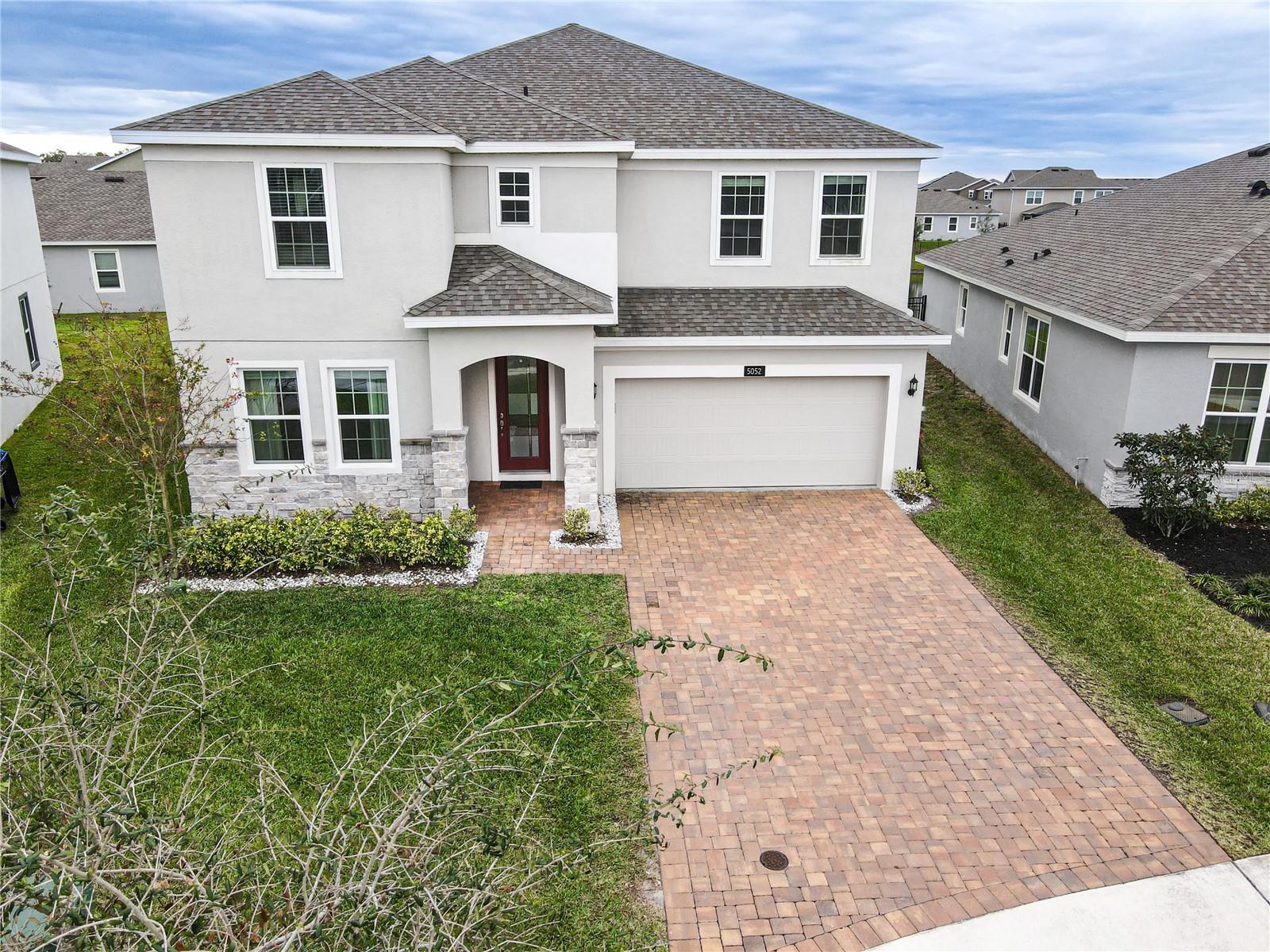 Beautiful FULLY FURNISHED 5 bedrooms, 3 full bathrooms, 2 car garage home, located in the highly desirable waterfront community of Hanover Lakes! Open Floorplan with Chef’s kitchen with Quartz Counters, Cabinets, center island, walk-in pantry, and spacious Living Room. Inside, the first-floor guest bedroom and bathroom provide convenience and privacy for visitors or as a home office. Upstairs, you'll find four generously sized bedrooms, a smart loft space, and a substantial primary bedroom that offers ample space for a sitting area. The master bath boasts a large garden tub, a separate shower, double sinks, and large walk-in closet. The remaining three bedrooms are generously sized and share a hallway bath with dual vanities. Covered Front Patio, Paver driveway and lush landscaping finish off this wonderful home. The community offers a boat lift system, connecting the canals of the Hanover Lakes community to the Alligator chain of lakes. You'll also enjoy fantastic amenities, including a refreshing pool, a covered playground, a mini soccer field, a dock, and a boat ramp.Conveniently located just 25 minutes from Lake Nona's premier shopping, dining, and medical facilities. Plus, you're only a short 40-minute drive away from the world-renowned Disney resorts, Universal Studios, Sea World, and easy access to Downtown Orlando via the nearby expressway. Don’t Miss This One!