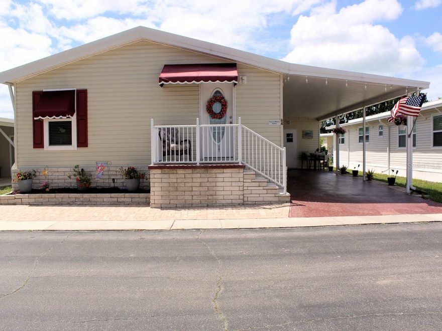 Are you ready to join a vibrant 55+ community that offers a wide range of amenities designed to keep you active and engaged? Palm Hill Country Club is a 55+ cooperative community that invites you to enjoy an exceptional lifestyle. Residents have access to pools, jacuzzies, a golf course, tennis courts, pickle ball, shuffleboard, clubhouses, bocce ball, billiards, and organized excursions, among many other activities. Palm Hill is known for its welcoming atmosphere, where friendly neighbors are always ready to greet you. The community provides a well-organized living experience with a single monthly fee of $595, covering water, sewer, trash removal, recycling pickup, lawn care, cable, and internet. Inside the comforts of Palm Hill Country Club is where you will find this 2005 two bed, two bath newer manufactured home.  The present owner has completed significant updates to the property since 2019. A roof-over was added in2019. In 2021 appliances and the kitchen sink were updated.  Pavers were added to the front and carport in 2022. Laminate floors and carpets with sub floors present a modern look.  In 2024 windows were replaced with double panes throughout, which created huge energy savings.  Both baths also have countertops replaced with appealing quartz.  The floorplan is both functional and attractive.  The kitchen and dining area have laminated floors. There is a kitchen table at the far end of the kitchen with a utility closet to one side.  The work area has stainless appliances on both sides for convenient use and a kitchen sink in front of a window.  Beyond the work area is the more formal dining space and to the left there is a natural flow to the living room. Bay windows allow light to filter inside.  The ceiling has an impressive, elevated area.  The bedrooms are separated by the living room.  The large primary is at the end close to the dining space and has a huge wall closet and an ensuite bath on the other side of the room.  The guest bath and guest bedroom lies off the far end of the living room. The home has an open airy feel, higher ceilings, wall color, and new style ceiling fans that are sure to attract.  The owners are in the process of deciding what furnishings will stay and will have a list. Driving by you will want to stop the car.  The exterior stands out with its newer look, light, colored siding, cozy front porch and long carport, big enough for two cars. At the end of the driveway there is an outside utility shed for more storage.  Please call to set up a time to see this striking home. If you are looking for a newer home this is a plus.  A share in the community is included.