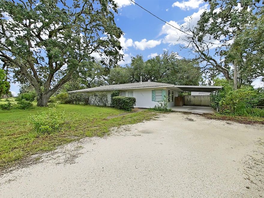 Welcome to this peaceful Spring Hill neighborhood! This single-family BLOCK home features 2 bedrooms, 1 bathroom, and a bonus room or 3rd bedroom, situated on 0.67 acres with a circular driveway and 1-car carport. It is almost 1400 sf in living space. This home has a living room and a family room, perfect for family gatherings, making memories. Enjoy an open floor plan with a spacious kitchen, equipped with a gas stove ideal for cooking and entertaining. Enjoy serene privacy under the shade of beautiful trees, with ample space for RV or boat storage. Recent updates include a newer roof (2020) and vinyl flooring.The fenced backyard offers privacy, and a large shed in the back offers extra storage. High and dry, this property requires NO flood insurance as well as NO HOA or CDD. Conveniently located near US 19 and Weeki Wachee Springs, perfect for outdoor enthusiasts who enjoy paddleboarding, kayaking, or visiting Buccaneer Bay Water Park and Pine Island beach.   Note:  This home doesn't have central A/.  For quicker responses, please TEXT Mindy with your questions.