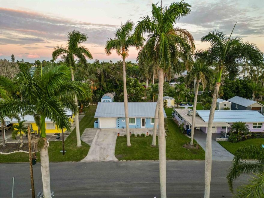 Come see this charming coastal retreat on a colorful Bay-view street near Cortez! This 2-bedroom, 2-bath home offers the perfect blend of comfort, style, and location—just a few short miles from the beach.

Step inside to find tile floors throughout, a newly renovated kitchen, and two fresh, modern bathrooms. The kitchen shines with 42-inch soft-close shaker cabinets, quartz countertops, and plenty of workspace for cooking or entertaining. Both bathrooms feature step-in showers, shaker cabinetry, quartz counters, and ample storage.

With a living room plus a family room, all painted in breezy coastal colors, there’s space to relax and spread out. From several spots in the home—and especially from the large front and rear patios—you’ll enjoy peek-a-boo views of Sarasota Bay. Picture yourself sipping an evening cocktail on the front patio while the sun sets, or strolling down Bayview Drive to take in the sights over Sarasota Bay and Longboat Pass.

Practical updates make this home move-in ready: double-paned impact windows, plantation blinds, ceiling fans, and an HVAC system and water Heater replaced in summer 2025. The metal roof (2012) provides long-lasting durability. An interior laundry and storage room, plus a spacious shed with electricity (contents included), add everyday convenience.

Whether you’re looking for a winter getaway, a full-time residence, or an investment property, this home offers it all—steps from the bay and minutes to the beach. Don’t miss this charming retreat!