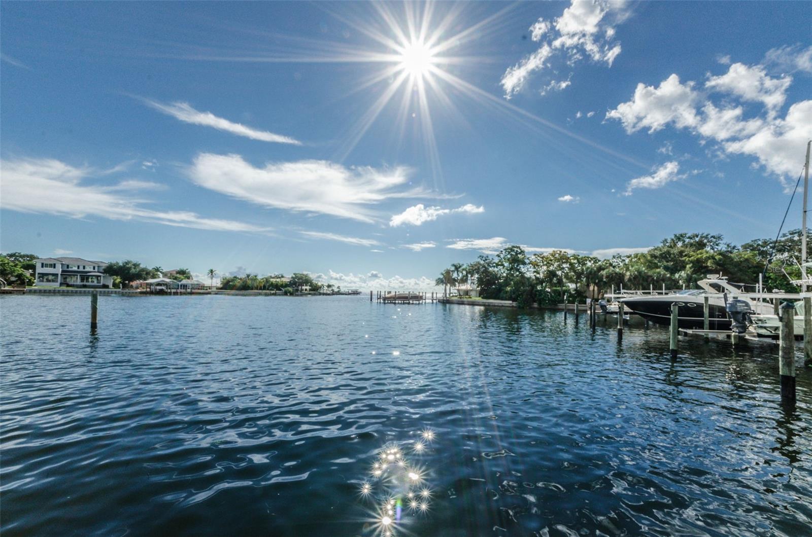 Welcome home to true Florida living! Situated in the gorgeous Snell Isle neighborhood, the exquisite Water Club boasts first class amenities with resort style living, while being only a few minutes waterfront drive to downtown St Pete. As you enter this unit, you will immediately notice the expansive views over Tampa Bay and Smacks Bayou. This open concept living allows the kitchen, dining room and living room to all have incredible views that can be enjoyed from all angles and the large balcony can be accessed by both the living room and the primary bedroom. High-end appointments throughout the unit include granite countertops, designer backsplash and stainless steel appliances. The grand primary suite has a large bathroom with a soaker tub, dual vanities and oversized shower. Custom closets provide plenty of closet storage and to top things off the stunning sunrise views can even be enjoyed from the comfort of your bed! In addition to the 2nd bedroom and bathroom the office area has a custom built murphy bed to accommodate additional guests with ease. The community clubhouse is home to the state-of-the-art fitness center, large clubroom with catering kitchen & meeting space. In addition you will enjoy the resort-style pool with spa, outdoor kitchen/covered bar area, waterfront fire pit, community kayak & canoe storage and deck & Harbor access