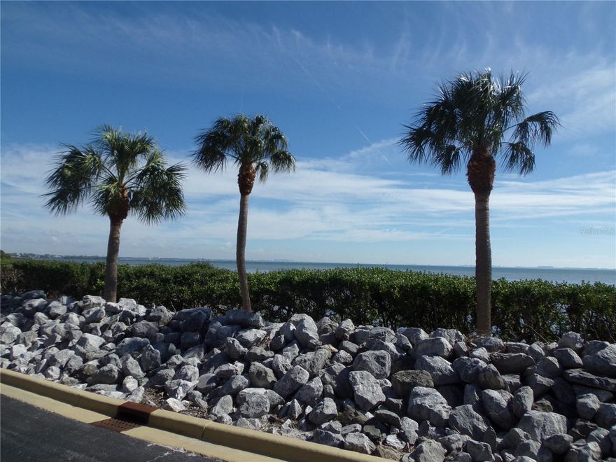 Fall in love with Conquistador Bay Club, an Elevated Waterfront Experience!  This Gorgeous 3rd Story End unit is graced with a Lanai that expands the entire length of the Unit! Wow...WHAT A VIEW! Impressive Breathtaking Beautiful Bay Views with a Sarasota Backdrop from your Private Verandah. Open the Blinds & Sliding Glass doors across the back to enjoy Nature's Bounty with sweeping views from your Great room as well.  Sit back, Relax & Enjoy Endless Sunsets alongside the Calm of the Water while sipping your morning coffee or evening cocktails as the Birds & Dolphins frolic about.  This 2-bedroom 2 bath Home is Turn-key Furnished & includes a Full size 2 car garage, a Large Storage area, and a Corridor with Private Elevator Access to your Home.   The Unit has been updated with Gorgeous Travertine tile in the main living areas & Ceramic Tile in the Baths and Lanai.  The Kitchen has Neutral Cabinets with Corian Counters and incorporates a Built in Desk, an Eat in Nook, a Breakfast Bar, a Rolling Island and a French door leading to an outdoor staircase.  This Unit has a large Great Room with a Dining Area, Fireplace and Pocket Sliding Glass Doors leading to the Lanai. This Gorgeous Premium End Unit is flooded with Natural Light due to its Southern Exposure.  A Neutral Color Palette has been utilized throughout the entire unit accented by Handsome Crown Moulding.  The Primary Suite flanks the Beautiful Bayside as well and has Full Length Sliding Doors to your Private Lanai, His and Her Closets, a Spacious En-Suite bathroom with Double Vanity, Wall Mirrors, Sitting Area for makeup & a Bathtub/Shower Combo with Shower Doors.  The Guest Room features a pretty view of the Pool, Spa and Courtyard.  The Guest Bath features a Vanity, a Linen closet and a Walk-In Shower with a Rain Shower attachment. The owner has installed a Bidet feature on the toilet as well.  NO Maintenance worries with its New A/C System (2023), New Hot Water Heater (2020), New Garage Door (2021).  A New Barrel Tile Roof will be installed in 2025 and has been paid for by the current owner!  Enjoy a stroll down the promenade for dinner at IMG's Semiprivate Waterfront Golf Clubhouse & Restaurant or enjoy a game of Tennis at the Bradenton Tennis Club to the north of the unit. What a way to start your day or end your evenings in style!  This is THE ONE! Where else can you find a Hidden Treasure that offers Peaceful & Private living with Stunning Million Dollar Views from your Residence with Sarasota directly across the Bay for $850k?  These units are rarely available & are a unique part of the El Conquistador Community with its Elevated Waterfront Buildings for Optimal Magnificent Views & Private Garden Oasis!  Make Conquistador Bay Club your Next Move...not only Gorgeous Water views, but also Beautifully manicured grounds, including Majestic Oaks, Mature Palm Trees, Tropical Foliage, a Beautiful Pond, a Promenade, a Rip Rap Wall & protected mangroves!  There is an inviting Community Pool & Heated Spa in the front of the Complex for your enjoyment.  The owner is leaving many extras including Decor, Window Coverings, Flat Screen TV's, Electronics, Air Fryer & other small appliances, as well as Bikes, Golf Clubs, Fishing Poles, etc.  The Conquistador Bay Club Buildings are Structurally Sound & have passed the required Milestone Inspection. Beautiful Beaches are minutes away! Don't miss this Exceptional Opportunity...Pack your Suitcase Now! Call today for your Private Showing.