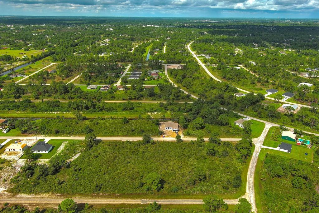 Photo of 642 Vasser Avenue S, Lehigh Acres, FL 33974 (MLS # O6343669)