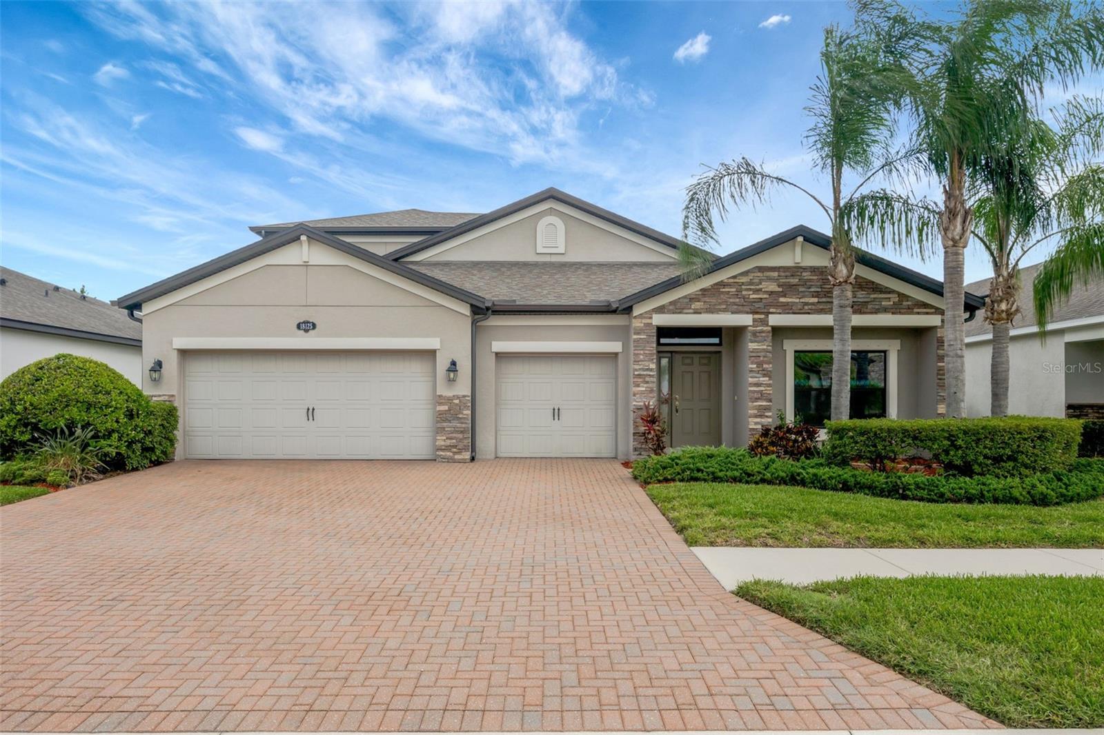 Welcome to this stunning 5-bedroom, 4-bathroom home with a 3-car garage, perfectly situated in the exclusive gated enclave of Primrose Estates within Long Lake Ranch! Nestled on a private conservation homesite at the end of a cul-de-sac, this beautifully appointed Covina II model by MI Homes offers style, comfort, and space for the whole family. Step inside to find high ceilings and elegant wood-look tile flooring throughout the main living areas. The thoughtfully designed split-bedroom floor plan features the spacious primary suite on the first floor, along with bedrooms 2, 3, and 4, a dedicated laundry room, an open-concept family room, and a large dining area ideal for entertaining. The upgraded gourmet kitchen is a chef’s dream, showcasing 42-inch cabinets, level 5 granite countertops, stainless steel appliances, a large kitchen island, and abundant storage. The primary suite is a relaxing retreat with a generous walk-in closet and a luxurious en suite bath complete with dual vanities, granite counters, a soaking tub, a walk-in shower, and a private water closet. Upstairs, you’ll find a spacious loft offering flexible living space perfect for a media room, play area, or home office, as well as bedroom 5 with a private full bath and large walk-in closet—ideal for guests, in-laws, or multigenerational living. Additional features include a stone-accented elevation, paver driveway, in-wall pest control system, and a screened-in patio overlooking serene conservation views. Residents of Long Lake Ranch enjoy resort-style amenities, including a community pool, playground, park, and scenic walking trails. This prime Lutz location is served by top-rated schools (brand new Skybrooke K-8) and is just minutes to the Suncoast Parkway, I-75, Tampa Premium Outlets, excellent shopping, dining, and entertainment options. Enjoy easy access to Tampa International Airport and some of the area’s most beautiful Gulf Coast beaches, including Clearwater Beach, St. Pete Beach, and Siesta Key. Don’t miss this rare opportunity to own an upgraded, move-in ready home in one of Lutz’s most sought-after gated communities!