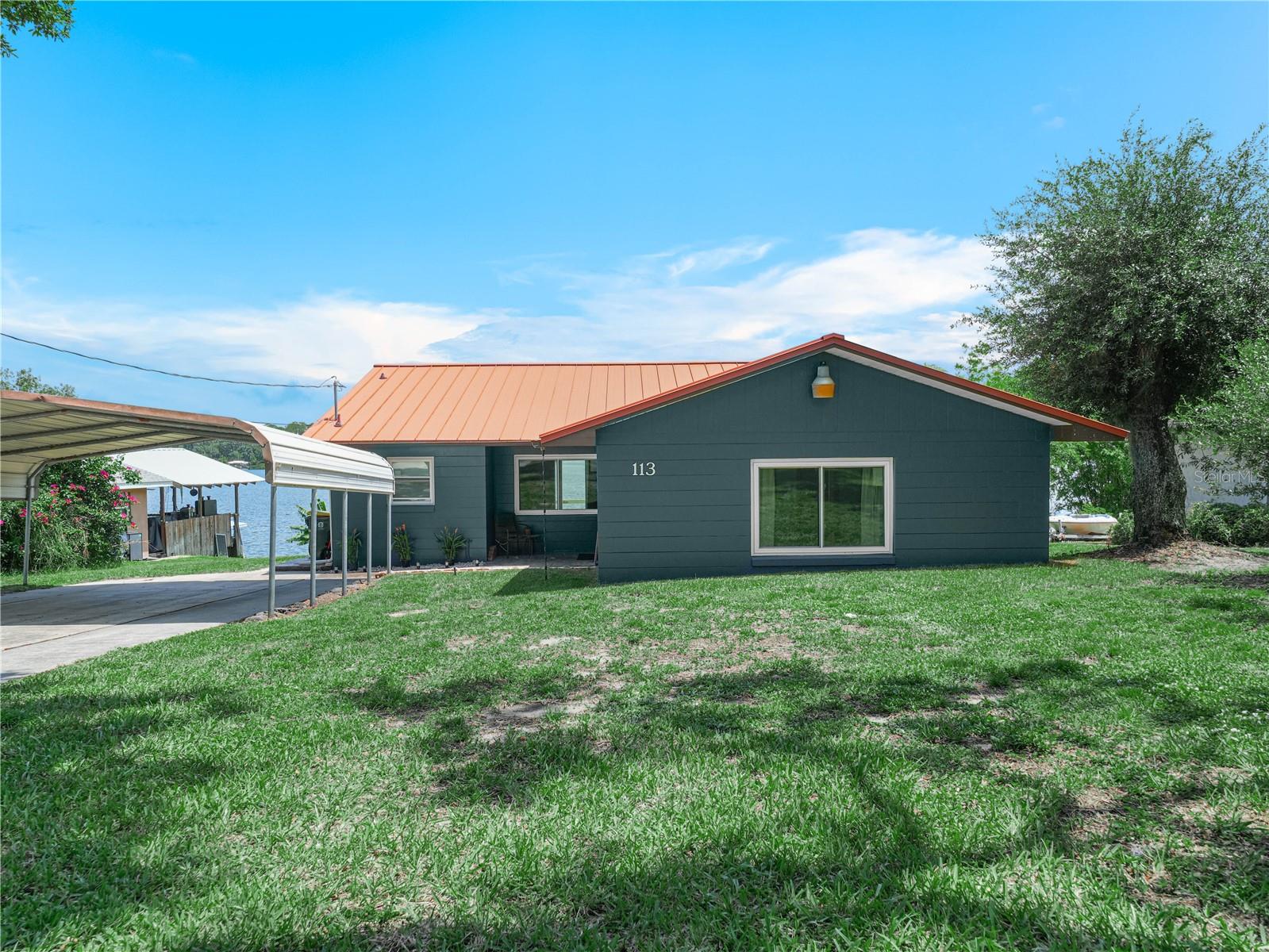 Discover this beautifully updated 3-bedroom, 2-bathroom home, perfectly situated on the shores of a serene spring-fed lake with crystal-clear waters. Enjoy incredible fishing right at your doorstep and take in the stunning views from your own backyard. This property features a spacious 2-car carport for convenience and is conveniently located just a short distance from town, making it an ideal blend of tranquility and accessibility. Updates include: Kitchen, including new Granite countertops, soft close cabinets, ventilation hood, large undermount sink, refrigerator and lighting. Bathroom was completely remodeled as well. Home has all new windows and a brand new 8 ft slider for a gorgeous view of the lake! New central A/C is to be installed April 2025. Don’t miss your chance to own this lakeside gem! Agent is related to owner. Property is currently leased, please do not disturb tenants. Listing information is deemed reliable but to be verified by Buyer/Buyer's agent.