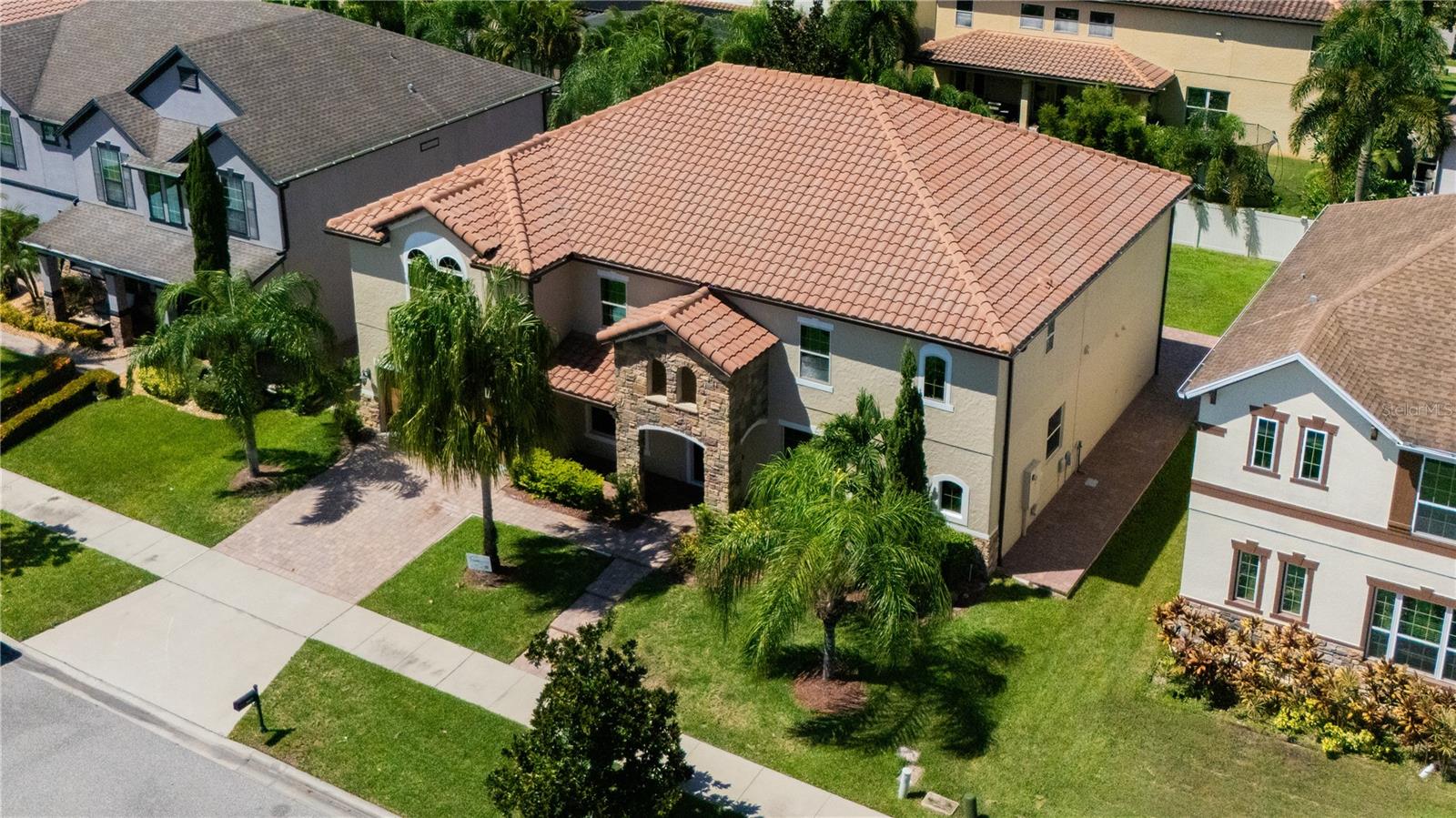 Interest rate to high to buy? This 6-bedroom, 6-bathroom luxury residence nestled in the highly desired community of Fells Landing in Lake Nona is ready for you to move in. Boasting just under 4,700 square feet of beautifully designed living space, this home offers the perfect balance of comfort, functionality, and elevated style. From the moment you arrive, you'll be struck by the massive, elegant homes that line Pummelo Drive — a quiet, upscale street that showcases the best of Fells Landing living. This residence stands out with its grand curb appeal, welcoming covered front porch, and thoughtfully upgraded interior finishes throughout. Step inside to an expansive open floor plan featuring designer accent walls, custom lighting, and a seamless flow ideal for both entertaining and everyday living. The gourmet kitchen is a chef’s dream, with granite countertops, a spacious island, stainless steel appliances, and ample cabinetry, all overlooking a bright and airy living and dining area. This home is ideal for multi-generational living with two bedrooms and two full bathrooms on the first floor, while the second level offers four additional bedrooms, a generous loft, and a home theater — perfect for movie nights or game days. The primary suite features a spa-inspired en-suite bathroom and an oversized walk-in closet. Enjoy the convenience of a downstairs laundry room, a 3-car garage, and plenty of storage throughout. Step outside to a private backyard ready for entertaining or quiet evenings. Residents of Fells Landing enjoy the serenity of a well-maintained community with beautifully crafted homes, manicured landscaping, and easy access to Lake Nona’s top destinations — including Medical City, Lake Nona Town Center, Boxi Park, top-rated schools, shopping, dining, and major highways. This is luxury living in one of Orlando’s most desirable neighborhoods — come experience it for yourself.