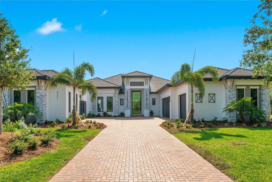 A very special place has a new, very special price...Reduced $355,000 from original price...Nestled in the serene and private setting of The Founders Club in Sarasota, Florida; this exquisite residence epitomizes luxury and sophistication. Completed in May 2024 by award winning home builder John Cannon Homes.  It is situated on a spacious, tropical landscaped, oversized private lot featuring a water view at the front and a golf course view at the back. YOUR next home has the continuity of 24” by 48” polished porcelain tiles throughout the entire home. The heart of the home, the great room, is magnificent and features a modern fireplace, cathedral beamed ceilings, beautiful light fixtures, a wet serving bar with ice maker and wine chiller, and 10-foot fully pocketing sliding glass doors that epitomizes the quintessential indoor-outdoor Florida lifestyle. The home is adorned with intricately designed ceilings throughout, which enhance each room with unique details and add a touch of elegance. Boasting an impressive architectural design, this property features four generously sized bedrooms and four meticulously designed bathrooms, each offering a blend of comfort and elegance. The gourmet kitchen is a chef’s delight, equipped with top-of-the-line Wolf appliances, sleek cabinetry, and beautiful quartz countertops. The outdoor area is a true oasis, perfect for entertainment and relaxation. It includes a stunning pool surrounded by lush landscaping, an expansive patio, and a refined outdoor living space, ideal for dining al fresco or enjoying peaceful evenings under the stars. Additional luxury amenities include a versatile flex space, which can serve as a home office, media room, or play area, and a detached exercise room offers a private gym experience right at home. This property offers not just a home but a luxurious lifestyle, making it a perfect sanctuary for those seeking comfort, privacy, and opulence in a distinguished golf course community. The lifestyle at Founders Club is unparalleled, offering a dynamic and enriching experience complete with your choice of membership levels: full golf, associate golf, or the social membership. Among the numerous club features available are an 18-hole championship golf course designed by Robert Trent Jones, Jr., state-of-the-art fitness center, tennis and pickleball courts. Strategically positioned close to downtown Sarasota, Siesta Key, UTC shopping complex, Lakewood Ranch Main Street and Lakewood Ranch Waterside, the Polo Club, all west coast Airports and pristine Gulf beaches, the community offers an abundance of dining, shopping, and entertainment options readily available for your enjoyment. Of course, a home of this caliber comes equipped with full hurricane / impact PGT windows and a whole house Generac generator. Contact us for a showing.  This one’s your new home!