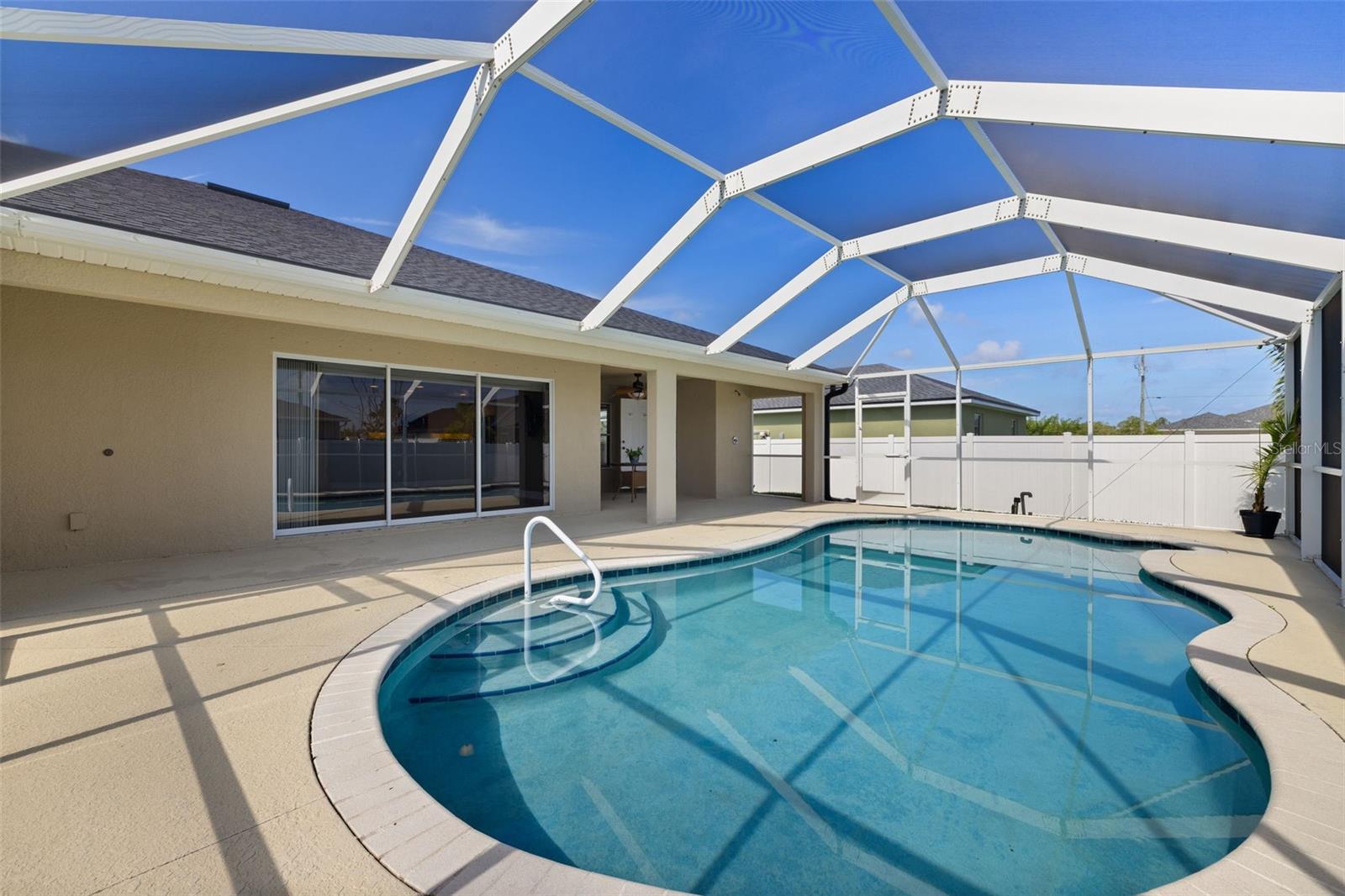 NO FLOOD INSURANCE REQUIRED. WHOLE HOUSE RO SYSTEM. POOL! Welcome to your own slice of paradise in beautiful NW Cape Coral! This stunning POOL home has everything you need to live the laid-back Florida lifestyle in comfort and style. Featuring 3 spacious bedrooms + a versatile den, 2.5 bathrooms (including a convenient POOL BATH), this home offers space to relax, work, and play. Inside, you’ll love the built-in desk area, perfect for remote work or a homework nook. The HUGE primary suite is a true retreat with an OVERSIZED walk-in closet that’s ready for all your beachwear and flip-flops. Brand NEW CARPET in the bedrooms adds a fresh and cozy touch, and the FRESHLY PAINTED EXTERIOR, giving the home a crisp, fresh look. Enjoy peace of mind with IMPACT WINDOWS, NEWER ROOF (2023) and a WHOLE HOUSE REVERSE OSMOSIS SYSTEM. Outside, your VINYL PRIVACY FENCE surrounds a relaxing backyard oasis, perfect for pool parties or quiet evenings. Located about 15 minutes to shops, schools, and Punta Gorda. This home is move-in ready and waiting for you to dive into that dream Florida lifestyle. Whether you're soaking in the sun by the pool or enjoying breezy evenings on the lanai, life is better in Cape Coral! Schedule your private showing today.