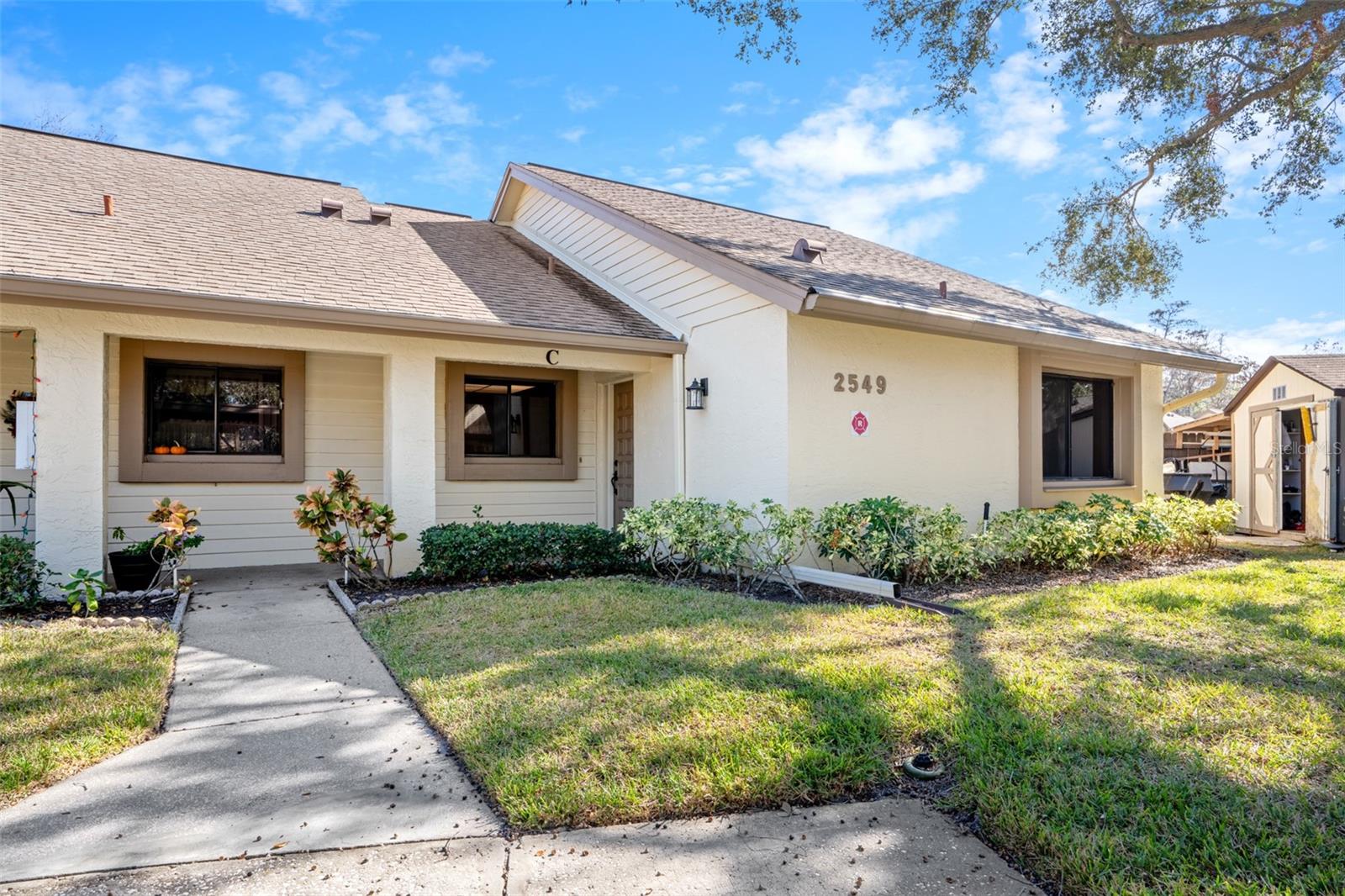 Welcome to Village on the Green! This 2-bedroom, 2-bathroom end unit offers a spacious layout featuring a walk-in closet, in-unit laundry, and a bright Florida room with serene pond views. Huge potential for updating and making it your own. Located in a vibrant 55+ community, you'll enjoy access to a lakeside pool, clubhouse, fitness center, library, and activity room, as well as organized events like exercise classes. The beautifully maintained landscaping, covered parking, and personal storage unit add extra convenience and charm. Don't miss out! Schedule your showing today!
