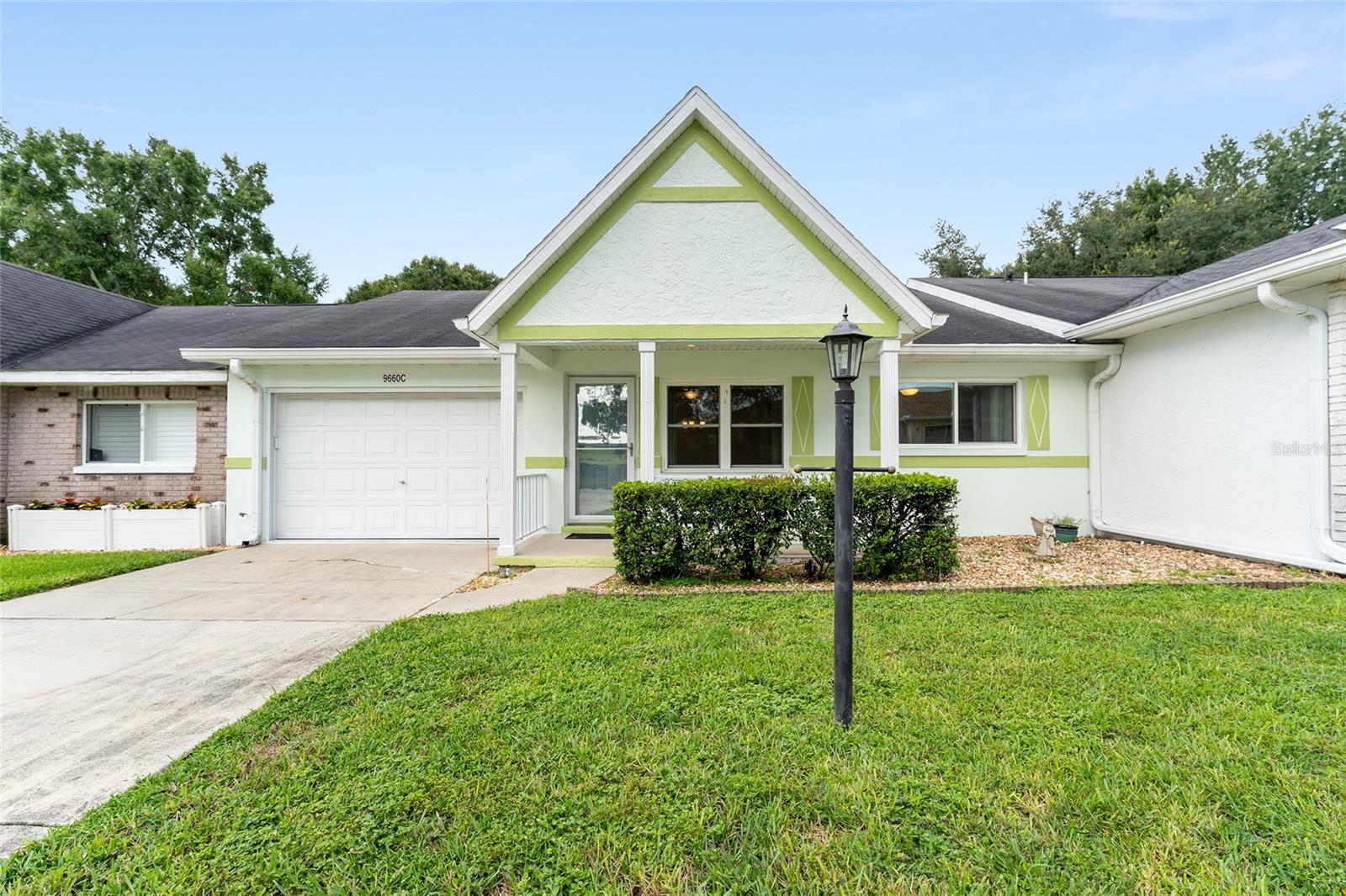 Welcome to this charming Grand Lafayette home in On Top of the World's Crescent Ridge neighborhood. Featuring 2 bedrooms, 2 baths, and a 1-car garage, this home is designed for comfort and convenience. Step inside to a spacious combination living and dining area, with a kitchen ready for all your culinary creations. At the rear of the home, you'll find a versatile bonus room; perfect for a home office, crafting space, or a cozy spot to unwind with your favorite shows. The enclosed lanai is the ideal place to enjoy your morning coffee, with neighbors behind set at a comfortable distance compared to many other villas, providing added privacy.
Another perk, your front view faces the Recreation Center, putting activities and amenities right across the street. Conveniently located near the Arbors, Recreation Center, and Veteran's Park, this home is also nestled in Ocala's premier active adult community, offering an abundance of amenities plus golf cart access to two shopping centers. Roof credit available with accepted offer.