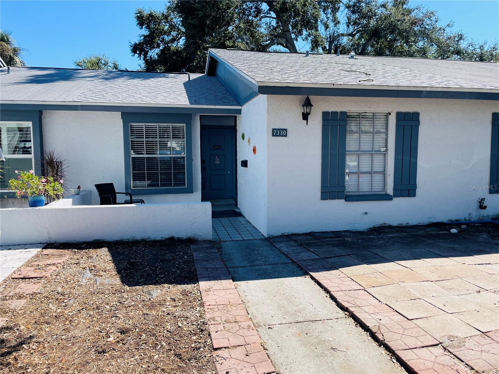 Charming 2BR/1BA villa for all ages in unincorporated St. Pete! Vaulted ceilings in the living/dining area create a bright, open feel. Easy-care tile flooring throughout—no carpet! Laundry closet in the unit and washer and dryer will stay. Roof replaced in 2022 and A/C approx. 5 years old. Includes assigned parking right in front of the unit. Low monthly fee of $185 covers pool, water, sewer & trash. Located in Flood Zone X (no flood insurance required by lender). Built in 1984 and in a well-maintained community where units can be rented—great for investors or full-time living. Two cats or dogs of any size allowed. Convenient to shopping, dining, and Gulf beaches. Don’t miss this affordable opportunity!