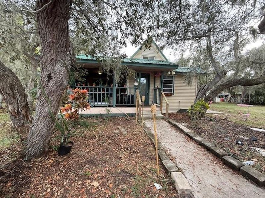 Just updated! What a unique property! Roughly 1 acre of land. Under the metal roof, there are beautiful granite countertops, luxury tile throughout so no carpet, stainless steel appliances, newly installed washer and dryer, high ceilings, large 2-car garage. Outside, you can marvel at the beautiful plants planted by the seller, large oak trees, recently built chicken coop and the large screened in pool. Property is not on city water, no HOA, virtually no restrictions, priced well below market, property is raised to high elevation with basement crawlspace underneath for maintenance. Don't miss this one of a kind property!