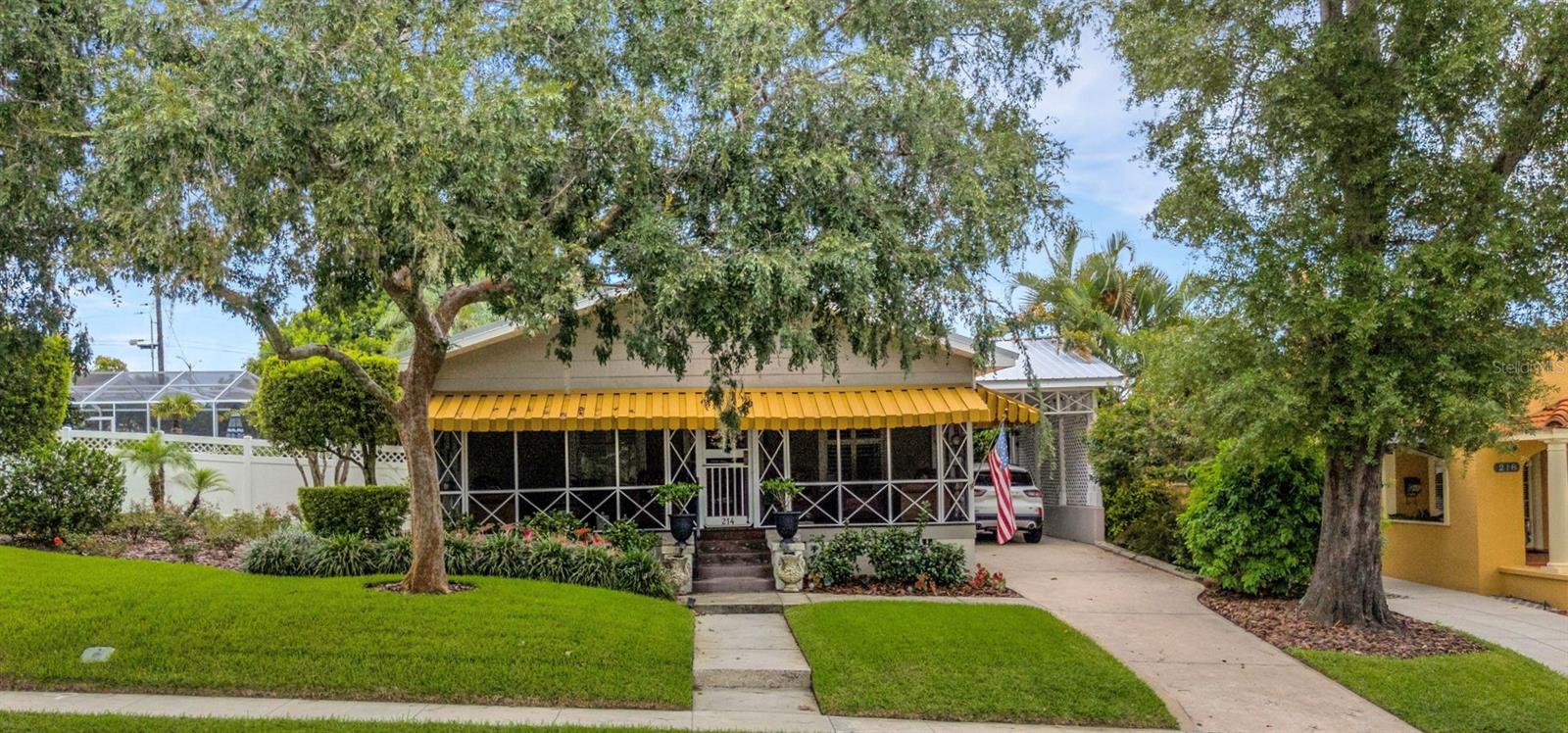 Welcome to Patten Heights – one of Lakeland’s most desirable neighborhoods! This charming 1938 bungalow is just a short stroll to beautiful Lake Hollingsworth and brimming with character, updates, and timeless appeal. Many original architectural details have been lovingly preserved, including large baseboards, rich wood floors, high ceilings, and classic dental moulding for hanging artwork. The formal dining room is enhanced by a Tiffany-style lamp, and the formal living room offers a working gas fireplace for cozy evenings.
Inside, you’ll find 3 bedrooms and 3 full baths. The updated kitchen features custom wood cabinetry, a central island with seating, granite counters, a farmhouse sink, and stainless-steel appliances (2019). Plantation shutters are found throughout, and the split bedroom plan offers flexibility—one guest room with a full bath makes an ideal office or den, while the second bedroom enjoys its own en-suite bath. A built-in ironing board in the hall, a large inside laundry closet (washer/dryer stay), and a gas hot water heater (2023) add convenience.
The spacious primary suite is a true retreat with two closets, an updated en-suite bath boasting a huge walk-in shower with dual shower heads, an electric fireplace, and an adjacent flex room—perfect for a nursery, office, or workout space. French doors lead from the flex room to an open Trex deck and a side screened porch. Outside, you’ll also find a relaxing spa, a beautifully crafted Amish shed with lighting and insulation (ideal for a she-shed or man cave), and lush, mature landscaping that creates a private, garden-like oasis.
Additional highlights include:
Centrally located screened porch off the kitchen, perfect for morning coffee or evening al fresco dining.
A rocking chair front porch with wood floors, two ceiling fans, and screens for year-round comfort adds Southern charm.
New metal roof (2022) with 3rd nail feature (2023).
New attic insulation (2021).
Upgraded electrical and plumbing.
Hardie board siding and plexiglass storm windows in the primary suite.
Whole-house generator (approx. 6 years old).
Two A/C units (2017 & 2020).
Irrigation system and fenced yard.
1 car covered carport plus additional parking.
Located close to shopping, dining, recreation, and top schools, this home offers the perfect blend of classic charm and modern convenience. This one won’t last long—schedule your showing today!