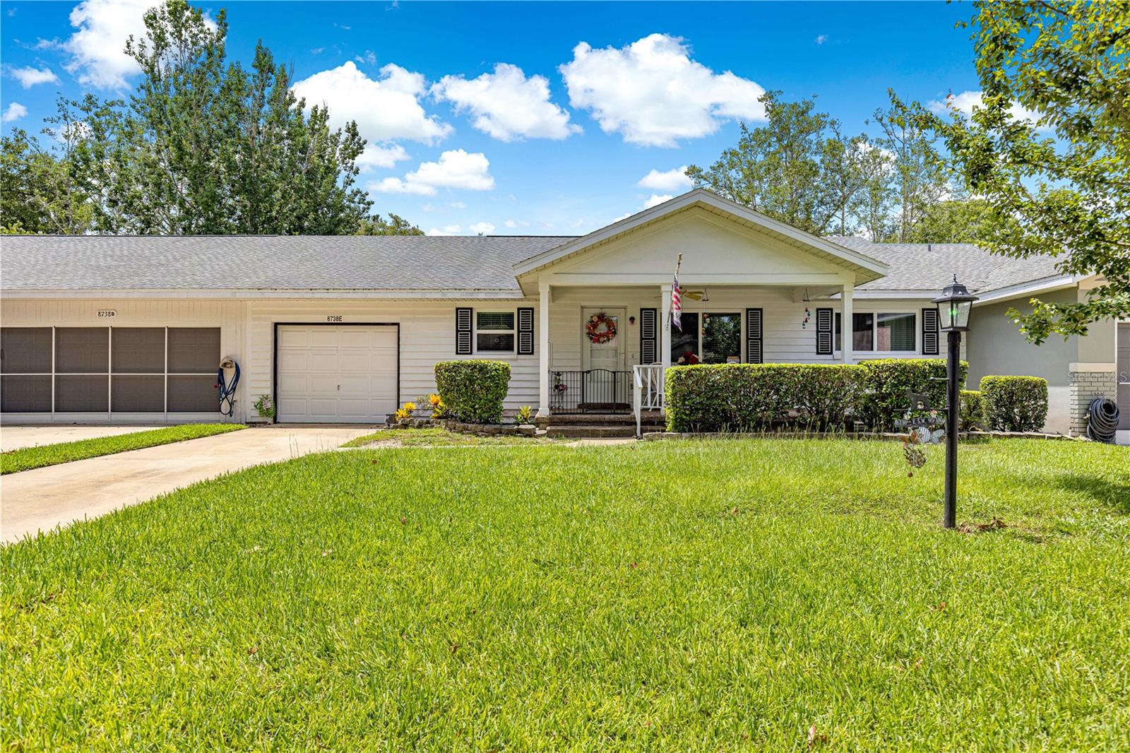 Expect to be impressed with this lovingly cared for furnished* move in ready villa with a terrific layout! This comfortable home boasts LARGE dining room, kitchen with bonus eat in area (can be used as breakfast nook or office) and quartz counters, stainless steel appliances and quartz backsplash. Enjoy years of care free living with the newer luxury vinyl floors (approx. 2 yrs) and a newer roof (approx. 7 yrs) and exterior painted less than 4 yrs ago. Ceilings have knock down ceiling texture and 2 sun tubes to let in the natural light. This home seems so much larger than its square footage implies boasting 2 large bedrooms and 2 generous baths with grab bars for safety. Enjoy the beautiful weather that Florida offers with it's front porch and even an oversized back lanai. This home has plenty of storage with walk in closet in the master bedroom, several deep closets, front coat closet and 35' deep garage with boards installed in attic for additional storage! The rear of the home also offers a spot to park your extra golf cart with electricity and gardening area! Previous owners were careful to keep the costs low with some newer double pane windows, gas A/C (inspected every 6 months) plumbed for gas stove and has a gas H/W heater. (*some furniture available separate from home sale)
