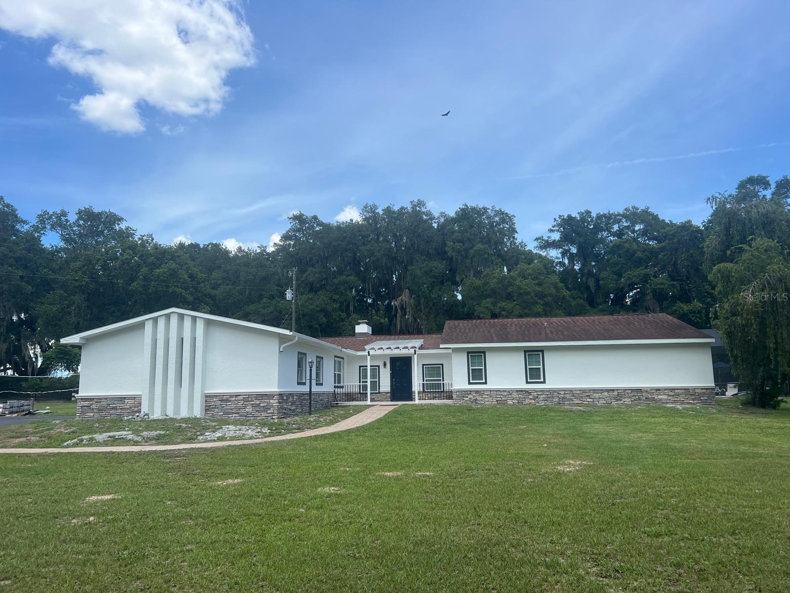 Beautiful Remodeled Country Home for Rent in Oxford – 1.8 Acres with Pool
Welcome to your peaceful retreat in Oxford, just steps away from US-301 and minutes from The Villages. Enter through a charming oak-lined driveway on a paved road that takes you straight to your door. Located on approximately 1.8 acres of lush green land, this spacious property offers the perfect blend of country living and modern convenience.
The main house features a remodeled kitchen with quartz countertops, 3 bedrooms, and 3 full bathrooms (including a convenient pool bath). Enjoy the oversized family room with a cozy fireplace, perfect for gatherings. Step outside to your screened-in pool area, ideal for memorable family days, volleyball games, or simply relaxing in the Florida sunshine. The front yard is partially fenced with wood accents, and there’s ample parking for guests and family.
This property consists of two dwellings: the main house (available for rent) and a separate 2-bedroom, 1-bath apartment, exquisitely remodeled and fully furnished, rented separately as a short-term rental. Tenants have the option to rent the entire property at an additional cost. See realtor remarks.
Bring your chickens, horses, or goats; parking trailers or RVs will be very easy here. Here you will enjoy the beauty of nature, breathtaking sunsets, and the tranquility of country life, but you will be only 5 minutes from shops, restaurants, hospitals, and businesses, and only 10 minutes from The Villages.
Here you’ll enjoy the beauty of nature, stunning sunsets, and the tranquility of country living—yet you’re only 5 minutes from shopping, dining, hospitals, and stores, and just 10 minutes from The Villages.
Please note: The property is currently occupied until November 1st. Showings are available by appointment only with 24-hour notice. Do not disturb the tenant.