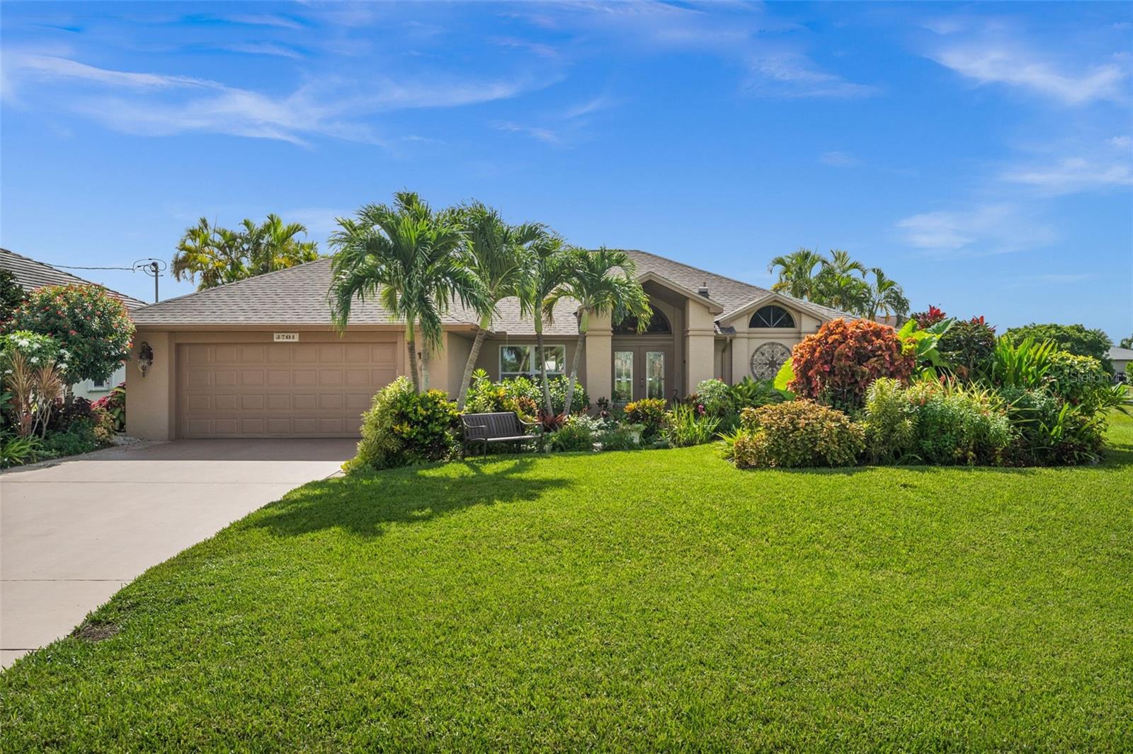 Welcome to your own slice of paradise in SW Cape Coral’s desirable Pelican neighborhood. This Gulf Access pool home sits on a 100-foot-wide canal and is just a short boat ride to restaurants, beaches and the Gulf. Surrounded by lush, meticulously maintained landscaping, the property feels like a private resort from the moment you arrive. Whether you're sipping coffee on the dock, hosting evening dinners poolside, or grilling under the gazebo, this home is built for the ultimate Florida lifestyle. The screened-in pool and lanai are surrounded by pavers, with lots of sliding doors for seamless indoor-outdoor living. A wooden dock and 10,000 lb boat lift with a brand-new cover make boating a breeze. The metal-roof gazebo on the paver patio offers one of the most unique and picturesque grill setups you’ll find anywhere. Inside, vaulted ceilings and skylights fill the great room and kitchen with natural light. The kitchen features granite countertops, tile backsplash, a breakfast bar, pantry, and all stainless Whirlpool appliances. Tile floors run throughout the home. The spacious master suite includes direct access to the lanai and pool, with a walk-in closet and beautifully tiled bathroom. The second bedroom features a large bay window overlooking the water and tropical gardens, while the third bedroom and second bath are perfect for guests. Additional features include impact windows throughout, hurricane shutters for the sliders, a laundry room, and even an HD antenna installed in the attic. This is more than a home, it’s a lifestyle. Come experience why so many dream of living the Southwest Florida waterfront life, and why this home is one you won’t want to leave.