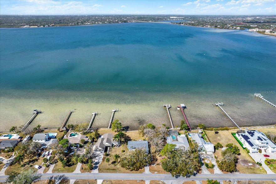 The Ultimate Waterfront Canvas: 150ft of Panoramic Bay Frontage. Secure a legacy-grade homesite on one of the most expansive waterfront lots in Oldsmar. Situated on almost ¾ acre on the prettiest street in Oldsmar, 400 Shore Drive E offers a rare 150 feet of direct, unobstructed frontage on Safety Harbor. This is a premier opportunity for a visionary buyer or elite builder to bypass the limitations of existing construction and design a bespoke custom estate from the ground up. While the current structure is a teardown (sold as-is), its presence provides a significant footprint and potential impact fee advantages for your new architectural masterpiece. Experience total privacy and some of the most breathtaking, wide-water sunset views found anywhere in the Tampa Bay region. Just minutes from the refined trails of RE Olds Park and the area’s top dining, this location perfectly balances secluded coastal living with urban convenience. Don’t just buy a home—build a landmark on the water’s edge.