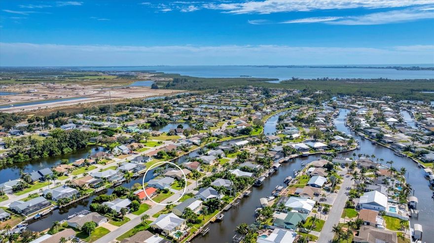 One or more photo(s) has been virtually staged. NEW PRICE, LOCATION, Opportunity, Possibilities, and MOTIVATED SELLERS that will pay your 1st year of HOA fees for $1,200. Make this property your home on the water in PARADISE!  Spacious 3 bedroom 2 bath waterfront canal home is located in the beautiful tree lined neighborhood of Coral Shores East. Just minutes from world class beaches and everything that makes the Florida lifestyle so desirable. The home is full of bright natural sunlight and has a split plan for privacy from your guest rooms. It features a Florida Room where you can entertain family and friends while looking out over the serene water. The updated kitchen features a cooking island, solid surface countertops, stainless steel convection range with cooktop and microwave, all complemented by rich ,warm cabinetry. There is ample eating space in the kitchen with water views as well.
For the boating enthusiast, this home is truly exceptional. situated on a freshwater canal with private, locked homeowner access, you'll enjoy no tidal fluctuations, reduced saltwater corrosion ,and a tranquil, low maintenance waterfront environment. A newly completed modern updated jib lift system provides quick and easy access to the open salt water canals-allowing you to boat, fish or kayak your way to the Intracoastal waterway and azure blue waters of the Gulf in just minutes. No Pool- No problem as you are surrounded by beautiful waters you can take a swim in without the cost of maintance. G.T. Recreation Center is minutes away with a large outdoor pool free to Residents. Join there and you have a gym, pickleball, tennis and much more close by.  Upgrades providing you piece of mind include a newly installed water heater, impact hurricane windows, newer A/C and shingle roof, property has beed meticulously maintained by the original owner!
 The home has a well for irrigation saving you on water bills and allowing you to keep the beautiful mature landscaping nice and green. The home has never experienced ANY FLOODING from past hurricanes.
Ideally located just minutes from Anna Maria Island, Longboat Key, St. Armands Circle, pristine Gulf beaches, IMG Academy, and top rated restaurants, golf, shopping, and SRQ/Bradenton Airport. This home allows you to own waterfront property and is priced accordingly allowing you to make it your dream home in paradise with your own design touches. 
This is your chance to embrace the Florida lifestyle- schedule your private tour today and make this waterfront oasis a reality