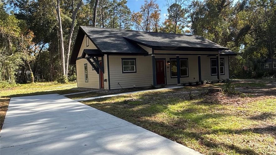 Under Construction. BRAND NEW Construction attention to detail 3bed/2bath gem with live oaks lining the half acre property and informing Micanopy's Tangerine Street. Designated one of "The 10 Best Small Towns in Florida" by Travel + Leisure Magazine (February 2023), Micanopy has kept its old town feel where neighbors wave to each other, the pace is slow, and local businesses sweeten the Town's charm. Enjoy walking the streets lined with old live oak and magnolia trees. "The town that time forgot", Florida's oldest inland town is like stepping back in time. Known for its antique shops, Blue Highway Pizza, Pearl's BBQ, and Mosswood Farm Store & Bakehouse. Micanopy is also home to both Paynes Prairie State Park and Price's Scrub State Park where you can regularly see wild horses, bison, whooping cranes, and alligators (of course). If you are looking for NEW home with modern conveniences while living in "the town that time forgot" within a short 15 minute drive to Gainesville, then this is the home for you! This home boasts two patriotic custom stained glass pieces on either end of the home, an open floorplan with a vaulted ceiling, lots of windows for great natural light, a screened in back porch and an open front porch, parking with electric vehicle charging, hookups for generator, energy efficient design, 9' ceilings and vaulted living room, solid wood kitchen cabinets with granite countertops and a large island with seating. Brand new stainless steel GE appliances, Hunter ceiling fans, delta plumbing fixtures, and a separate laundry room with storage closet. The primary bedroom is separated from the other bedrooms and boasts a tray ceiling, walk in closet, double vanity, and custom tiled black and white shower. Feels much larger than 1241 sqft.