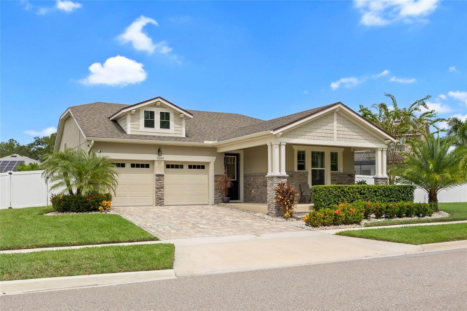 Live just minutes from the magic of Disney World! This beautiful 4-bedroom, 3-bath home offers nightly views of Disney fireworks from your charming front porch and a resort-style lifestyle right in your own backyard. Sitting on an oversized .27-acre fenced lot, there’s plenty of room for pets to run freely or to add a playground or garden oasis. The backyard is beautifully landscaped with manicured greenery and palm trees, creating a private tropical retreat. Enjoy year-round fun in your screened-in, heated saltwater pool—perfect for cooling off on hot summer days or entertaining guests in every season. Built in 2020, this home offers 2,449 sq ft of open living space, featuring a modern kitchen with granite countertops, 42” cabinets with crown molding, dual ovens, stainless steel appliances, and recessed lighting. The open layout seamlessly connects the kitchen, dining, nook, and family room—ideal for gatherings. Additional highlights include a Jack-and-Jill bath between the 2nd and 3rd bedrooms, paver driveway, lanai, stone elevation, Ring doorbell and cameras (included), and a well-equipped laundry room. With exceptional curb appeal and prime location near world-class attractions, dining, and entertainment—this home truly offers the best of Florida living!