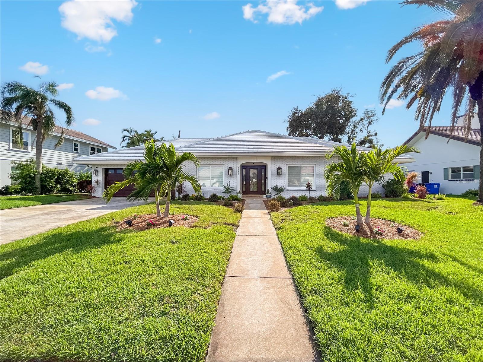 Welcome to Bayway Isles, one of St. Petersburg’s most exclusive guard-gated, waterfront communities. Just across the bridge from the award-winning beaches of St. Pete Beach, Pass-a-Grille, and Treasure Island, and only ten minutes from the vibrant downtown St. Petersburg. This location offers the perfect balance of coastal living and city convenience. This beautifully newly renovated single-story pool home features 3 bedrooms and 2 bathrooms with a modern coastal charm. The BRAND NEW kitchen is a chef’s dream, showcasing solid wood cabinetry, stone countertops, under-cabinet lighting, new stainless-steel appliances, a spacious island for gathering, a breakfast bar, and a walk-in pantry. The kitchen flows seamlessly into the light-filled family room, creating the ideal space for entertaining. Throughout the home, newly installed hardwood-style porcelain tile flooring enhances the clean and elegant design. Both bathrooms have been tastefully updated with modern tile, cabinetry, and fixtures, while the large indoor laundry room has been redesigned with custom cabinetry for added convenience. A formal living room and dining room provide flexible spaces to fit your lifestyle. Step outside to your private backyard oasis, where a large in-ground pool is surrounded by lush landscaping. A screened-in porch offers the perfect spot to enjoy evening breezes in comfort and privacy. Additional features include hurricane impact windows and sliding doors, a brand-new 2024 HVAC system, updated lighting and fans throughout, and a spacious two-car garage. This move-in ready home combines thoughtful upgrades with timeless appeal, offering everything you need to enjoy the best of Florida living.
