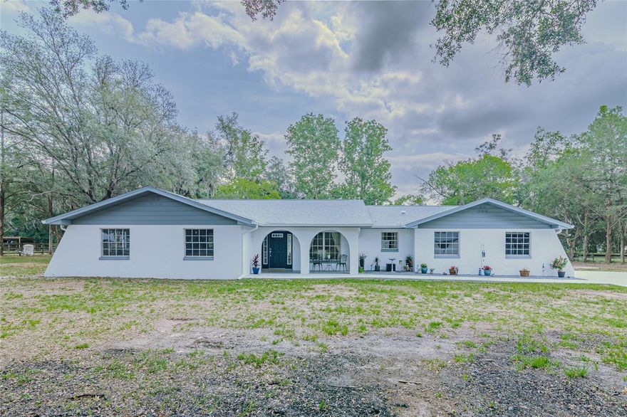 B-4 ZONED PROPERTY ON 2.27 ACRES! REMODELED 3BR/2BA/2GA HOME! DETACHED 3-CAR GARAGE WITH OFFICE/STORAGE ROOM! RV CARPORT! This versatile property offers options for multi-family living or running your specialty business. Tucked away on a private drive off the main road, this house is surrounded by other farms. Gorgeous home is move-in ready with fully remodeled interior, welcoming foyer, open living room & dining room, eat-in kitchen with plenty of cabinets & luxe countertop, spacious primary suite with walk-in closet & dual vanity in bathroom, 2 spare bedrooms & guest bath, huge laundry room & side-loading double garage. Detached garage includes double & single bays, extended covered parking, separate office, 3 separate storage rooms, & a half-bath that could easily be converted into a separate residence. Extras include 2 storage sheds, a lean-to carport, RV carport on concrete pad, new driveway & extended front porch, citrus trees, beautiful oaks & landscaping. The fenced 2.27 acres has a double gate entry. NEW roof, flooring, paint, kitchen, baths, gutters, MORE! A HIDDEN GEM IN NE OCALA!
