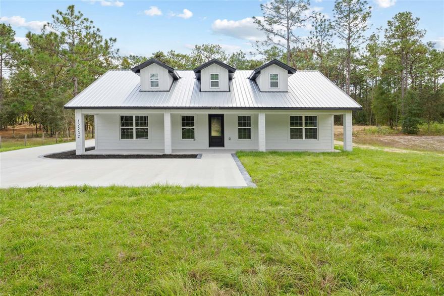Under Construction. Welcome to your brand-new modern farmhouse retreat  This home blends clean lines with classic charm, featuring a metal roof, a wide covered front porch, and three eye-catching dormers that give the exterior timeless character. Inside, you’ll find an open concept layout with high ceilings, a spacious Great Room, and a smooth flow to the dining area and kitchen, perfect for everyday living and entertaining. The kitchen is the heart of the home with a center island and plenty of counter space.

The split floor plan gives privacy with the owner’s suite tucked away and a generous walk-in closet. Two more bedrooms and a full bath offer flexibility for family, guests, or even a home office. Step outside and enjoy the oversized covered lanai, a great spot for relaxing or gatherings. The side-load 2-car garage adds convenience and enhances the curb appeal, all set on a peaceful lot surrounded by nature.

This is your chance to own a new construction home with timeless style and modern comfort, ready for you to make it your own.