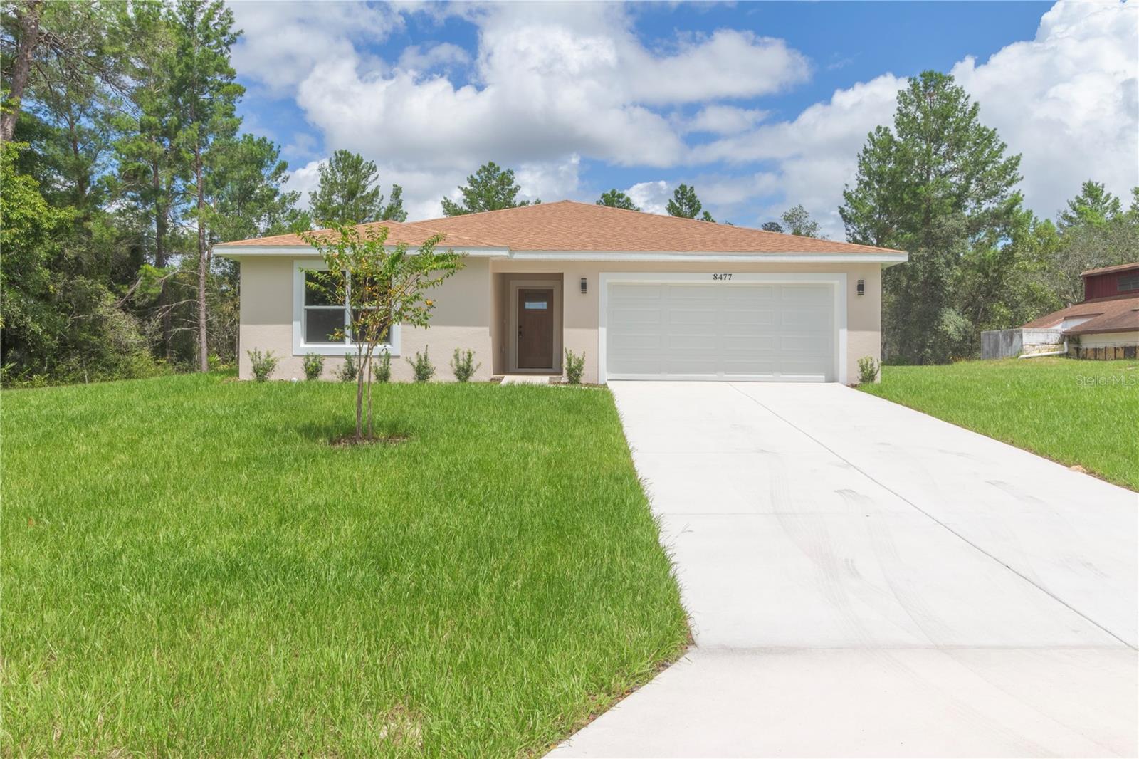 Welcome to this one-of-a-kind, newly built 3-bedroom, 2-bathroom home in the heart of Spring Hill. Offering 1,828 sq. ft. of open, light-filled living space, this residence features high-end finishes throughout, including waterproof luxury vinyl plank flooring, ceramic tile in the bathrooms and laundry, and 34” solid plywood kitchen cabinets with Moen fixtures. The gourmet kitchen is equipped with Frigidaire stainless steel appliances, and an LG washer and dryer are included for added convenience. The spacious primary suite boasts thoughtfully selected finishes and a luxurious bidet toilet. Built with durability in mind, the home has been painted with premium Sherwin-Williams products inside and out, while the bathrooms feature reinforced waterproofing for long-term protection. Additional highlights include impact-rated vinyl garage doors, a three-car garage with epoxy-coated floors, and epoxy-finished front and back porches. Located in a quiet neighborhood with NO HOA or CDD fees, offering you more freedom and centrally positioned near everything you need, this move-in ready home is a must-see!