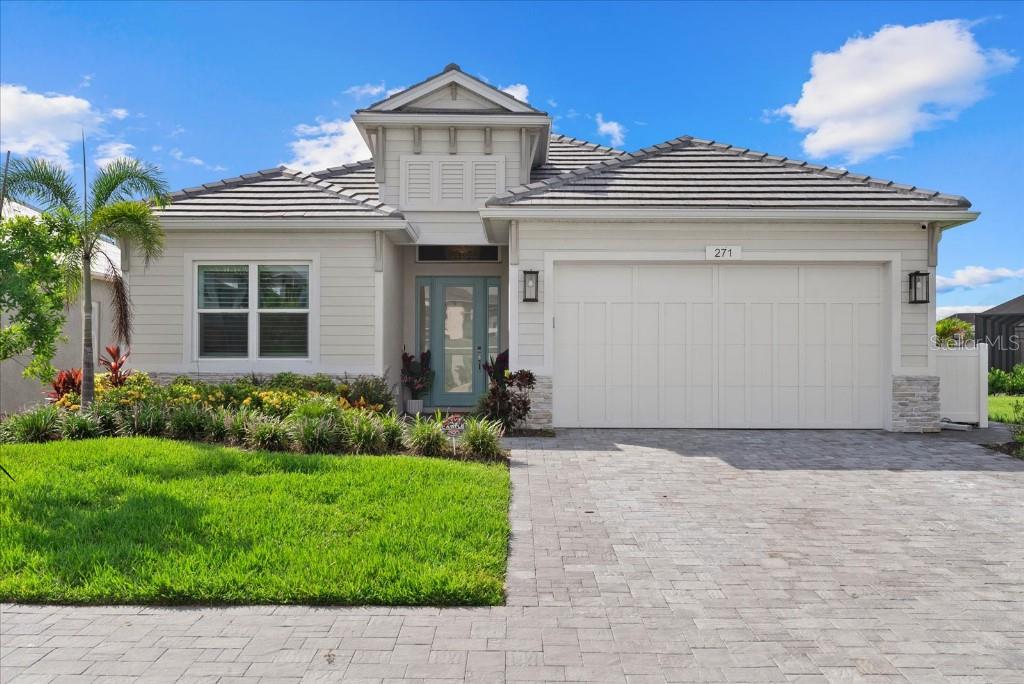 Step into unparalleled coastal elegance with this stunning home, where architecture meets serene water views to create a true sanctuary. Meticulously designed with a one-of-a-kind floorpan customized by the seller, this one-year-old residence boasts over $180,000 in designer-selected finishes and structural upgrades—both before and after construction—reflecting uncompromising quality and timeless sophistication. The chef’s kitchen is a culinary masterpiece, equipped with an oversized cooktop and range hood, built-in wall oven and microwave, custom glass backsplash, and gleaming quartz countertops. Throughout the home, designer-selected luxury finishes, plantation shutters, and luxury vinyl plank flooring elevate every space with enduring style and comfort. The extended primary suite provides a private haven, featuring elegant French doors, spacious his-and-hers walk-in closets, and a spa-inspired bath with a freestanding tub and expansive walk-in shower—an intimate retreat designed for ultimate relaxation. Two additional generously sized bedrooms and a spacious home office provide versatile living and work-from-home options, thoughtfully crafted to balance privacy and connectivity. Enjoy seamless indoor-outdoor living with a fully screened extended lanai and a fully fenced, expansive backyard—perfect for pets and play—pre-wired for a private pool and pre-plumbed for a whole-house generator and outdoor kitchen, offering unmatched convenience. Spray foam insulation beneath the entire roof ensures maximum energy efficiency year-round. The oversized garage, extended by four feet, provides ample storage and versatility, complemented by impact-resistant windows and doors throughout the home that provides peace of mind and durability. Situated on a premium, extra deep corner-adjacent lot, this home provides abundant open space and privacy, while positioned just steps across the street from the exclusive resort-style amenities center. Nestled within the gated Watercolor Place community, residents enjoy access to a beach-entry pool, fitness center, and clubhouse. The location is exceptional—minutes from Lakewood Ranch, University Town Center, pristine beaches, and I-75—with no CDD fees. Low HOA dues include cable, internet, landscaping, and access to all community amenities. This coastal luxury gem perfectly balances great living, functional design, and breathtaking natural beauty. Experience elevated coastal living at its finest—your private retreat awaits.
