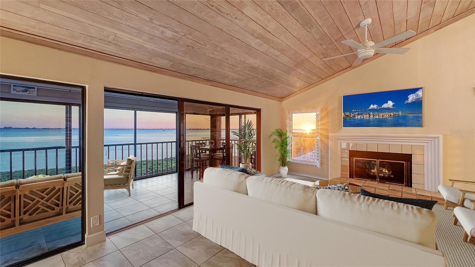Waterfront views without the waterfront stress? This is the one! Luxury elevated living directly on Sarasota Bay offers stunning waterfront views with mainland convenience and peace of mind. Impact windows, brand-new roofs just installed, milestone structural integrity inspection passed, and association reserves funded (per reserve study). Private two-car garage plus ~250 sq ft of climate-controlled storage on the ground level. Take the private elevator up (no stairs required) to the single-level living area perched directly on Sarasota Bay. Soaring vaulted ceilings with tongue-and-groove finishes, plantation shutters, and a wood-burning fireplace make the Great Room the heart of this 2,100 sq ft coastal retreat, where natural light and breathtaking bayfront views take center stage. This peninsula-like vantage point ensures extraordinary, uninterrupted views — golden sunsets can be enjoyed from the enclosed patio, the formal dining room, and even while standing at the kitchen sink. The enclosed patio offers amazing flexibility: 350+ sq ft with sliders open for a fresh bay breeze or closed with the dedicated AC split system for comfortable water views in all seasons. You simply must see the Downtown Sarasota skyline and Ringling Bridge lit up at night. An updated kitchen with a tasteful coastal ambiance features a custom Italian glass backsplash and premium Bosch dual wall ovens. Tucked away from the entertaining space, the primary suite offers its own water views and a spacious ensuite. The versatile guest bedroom includes a custom Murphy bed built-in — perfect for visiting guests or easily converted back into a quiet home office. Various interior storage closets, along with a full-size washer and dryer, provide the comforts of a single-family home. Tucked quietly away from busy downtown or barrier island traffic, you’ll enjoy a natural waterfront experience while being just a 20-minute drive to Downtown Sarasota or Anna Maria Island. Conquistador Bay Club is a boutique development with only 28 units spread across five buildings, where residents enjoy a community pool and spa along with private kayak access. The elevated block construction stood strong through the active 2024 storm season, offering lasting peace of mind for years to come. IMG Golf and waterfront dining are just a chip shot away in this quiet, bike-friendly neighborhood. A short drive to SRQ Airport, this residence offers the perfect balance of seclusion and accessibility. Easy to show — reach out to see the remarkable waterfront views in person!