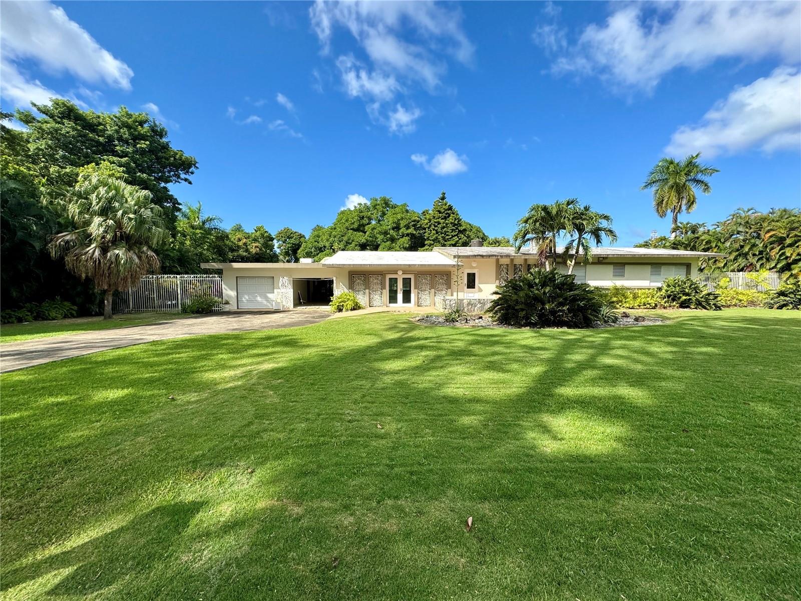 Nestled in the exclusive enclave of San Patricio, Guaynabo, this mid-century one-level residence seamlessly blends classic charm with modern potential. Offering approximately 3,000 square feet of interior space, this home provides a spacious canvas for your unique vision.
The expansive 5,000 square meter flat lot includes both front and back yards, perfect for entertaining or crafting your dream outdoor oasis.
Located in a gated community with 24/7 security, this property offers the ideal combination of privacy, convenience, and the opportunity to create your perfect home.