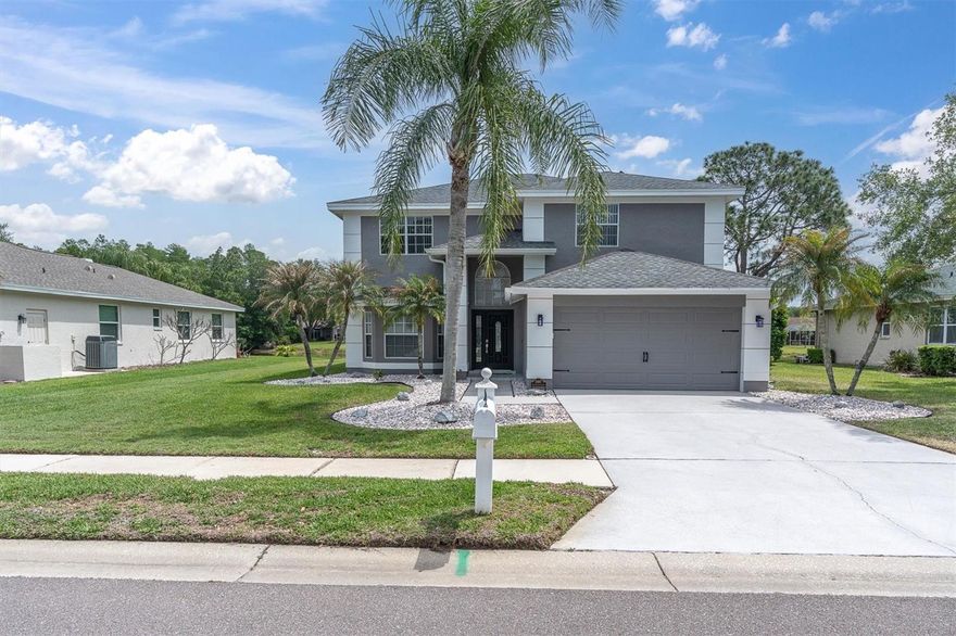 Welcome to Bridlewood at Tarpon Springs in Palm Harbor, FL, where space, style, and location come together in this beautifully maintained 4 bedroom, 2.5 bath, 2 car garage pool home offering over 3,000 square feet of living space. With low HOA fees and key updates including A/C (2020), water heater (2025), newer appliances, and a freshly painted exterior in (2026), this home is move-in ready and designed for comfortable Florida living. A grand two-story entry welcomes you into a spacious formal living and dining room, perfect for entertaining. The open-concept layout flows seamlessly into the kitchen featuring granite countertops, white cabinetry, tile flooring, stainless steel appliances, a breakfast bar, and an eat-in space overlooking the pool and pond. The kitchen opens to a large family room with a wood-burning fireplace, vaulted ceilings, and sliding glass doors leading to the covered lanai and sparkling pool. Enjoy serene pond views and a beautifully landscaped backyard, creating the perfect outdoor retreat. Upstairs, a catwalk overlooks the family room, enhancing the home’s open feel and architectural appeal while connecting the spacious guest bedrooms, including the primary suite. The primary bedroom is located upstairs and offers a private ensuite bath with dual sinks, granite counters, a soaking tub, and a separate walk-in shower. A first-floor bedroom, currently used as a home office, provides flexibility for guests or remote work. Additional guest bedrooms are generously sized, offering plenty of space for family and visitors. Located in the desirable Bridlewood community, this home is close to top-rated schools, parks, golf courses, shopping, dining, and the Gulf beaches. Enjoy easy access to major roadways, making commuting to Tampa and surrounding areas convenient while still enjoying the charm of Palm Harbor living.